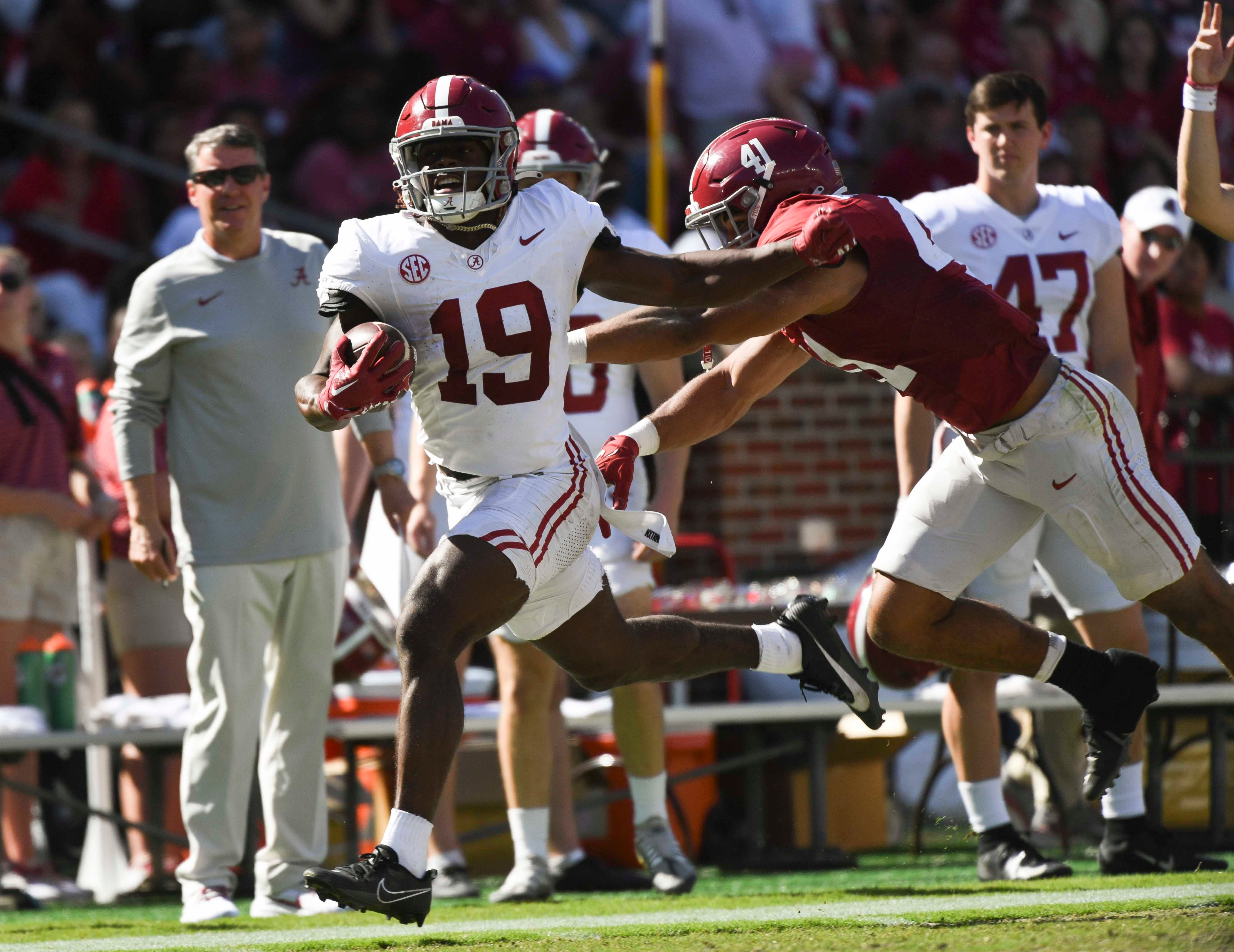 Apr 13, 2024; Tuscaloosa, AL, USA; Alabama wide receiver Kendrick Law (19) is shoved out of bounds by defensive player Justin Okoronkwo (41) at Bryant-Denny Stadium.