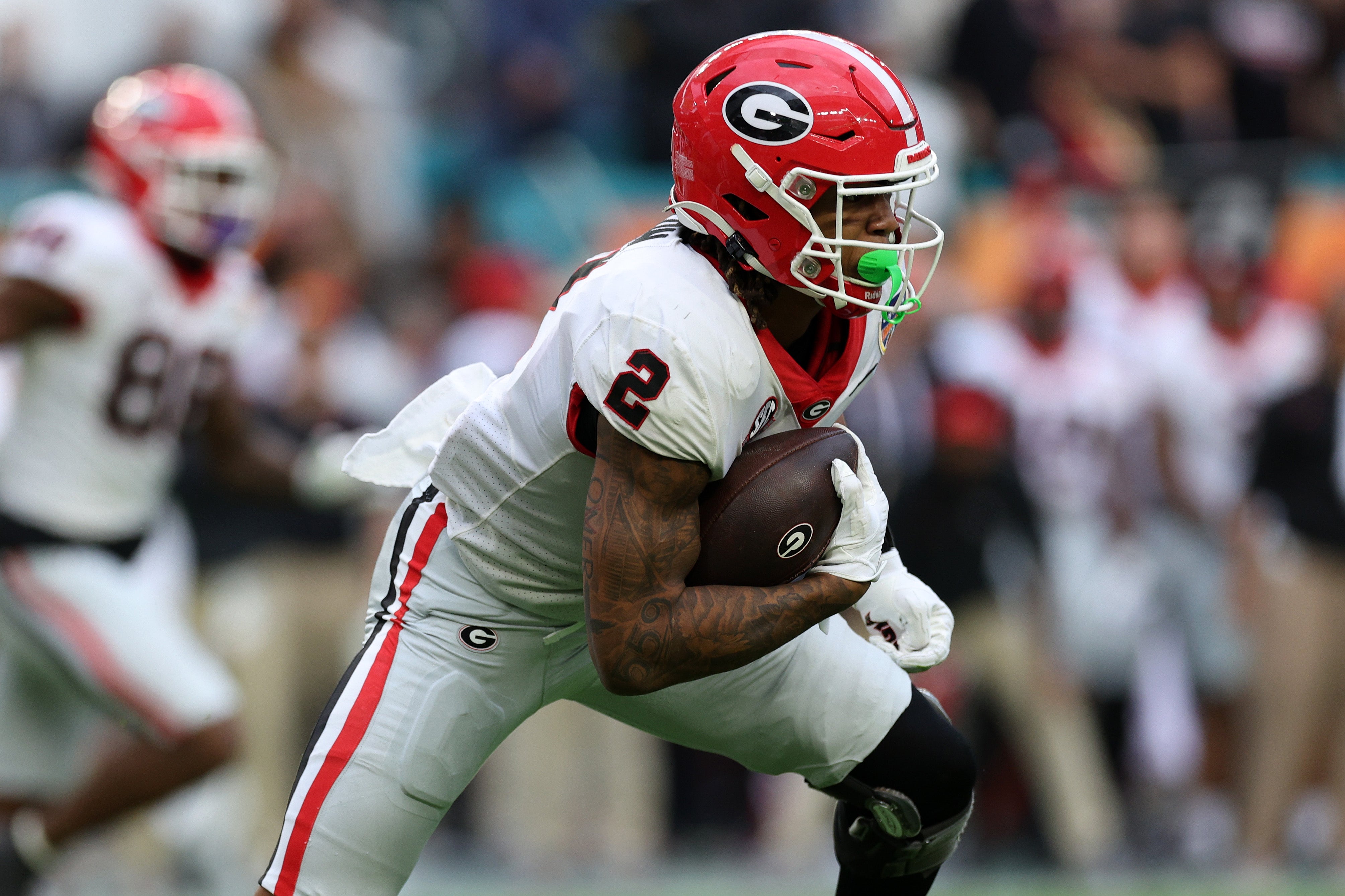 Georgia Bulldogs running back Kendall Milton (2) rushes for a touchdown against the Florida State Seminoles in the first half during the 2023 Orange Bowl at Hard Rock Stadium.