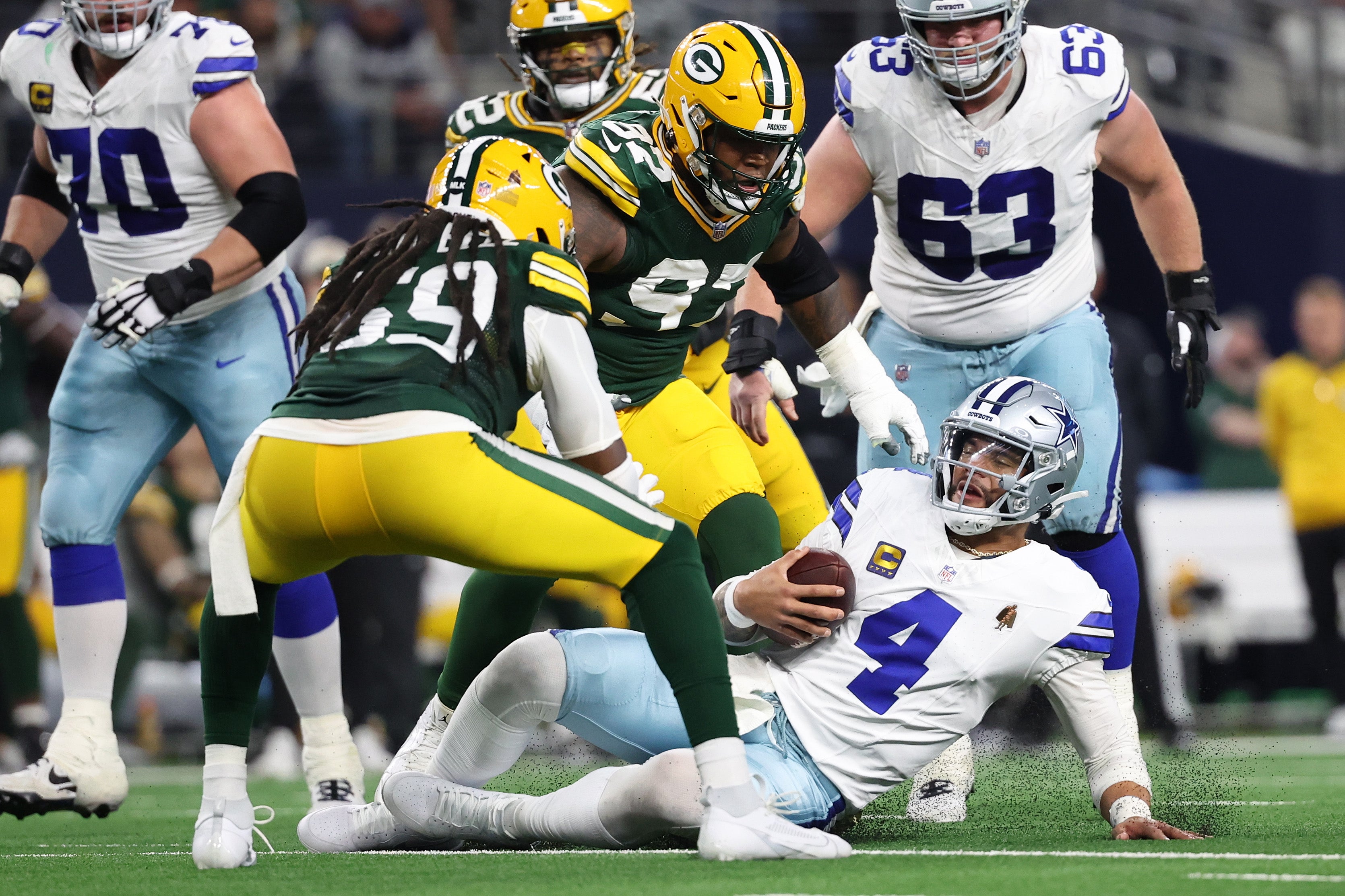Dallas Cowboys quarterback Dak Prescott (4) slides after running the ball against the Green Bay Packers in the second half for the 2024 NFC wild card game at AT&T Stadium.
