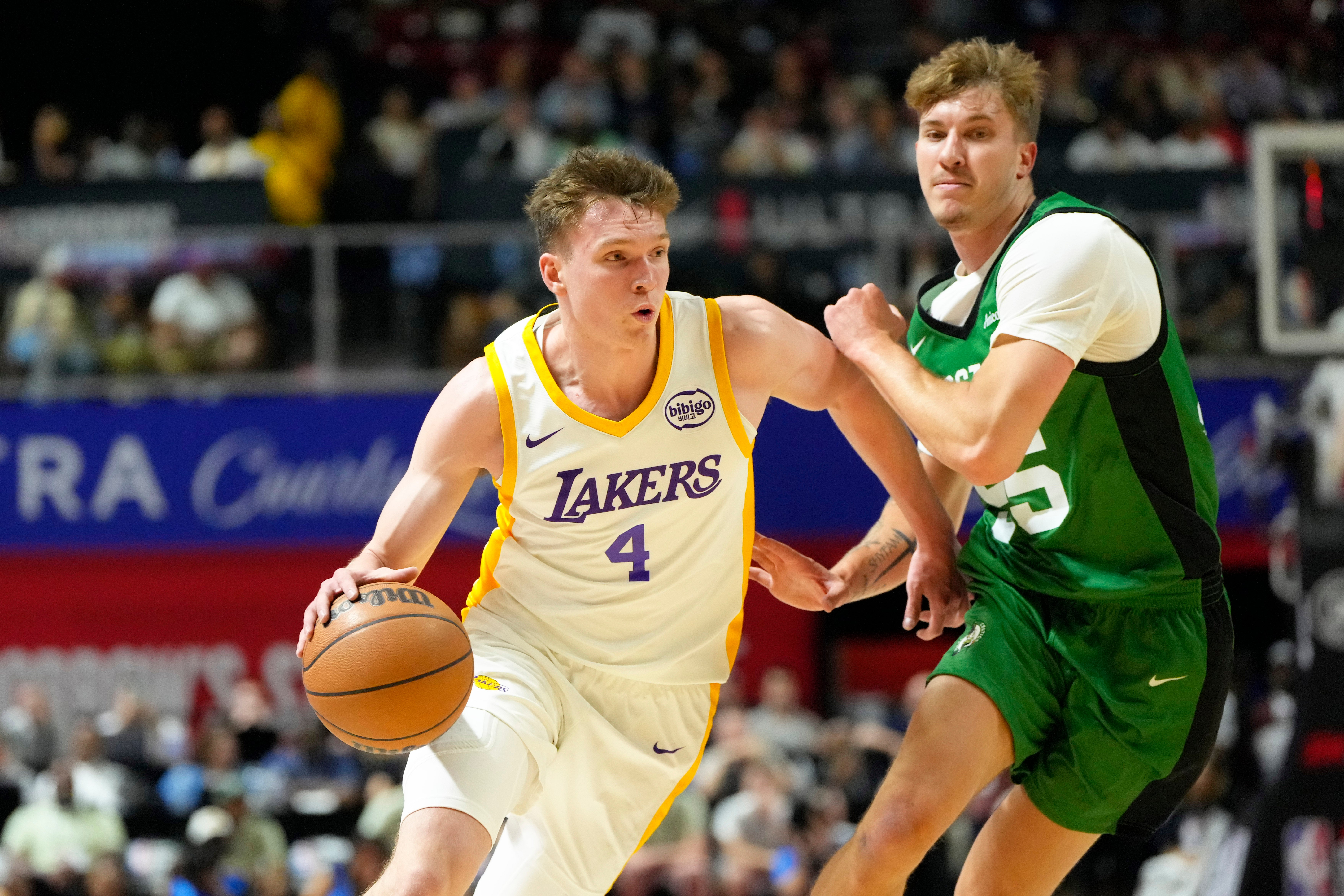 Jul 15, 2024; Las Vegas, NV, USA; Los Angeles Lakers forward Dalton Knecht (4) drives the ball against Boston Celtics guard Baylor Scheierman (55) during the first half at Thomas & Mack Center.