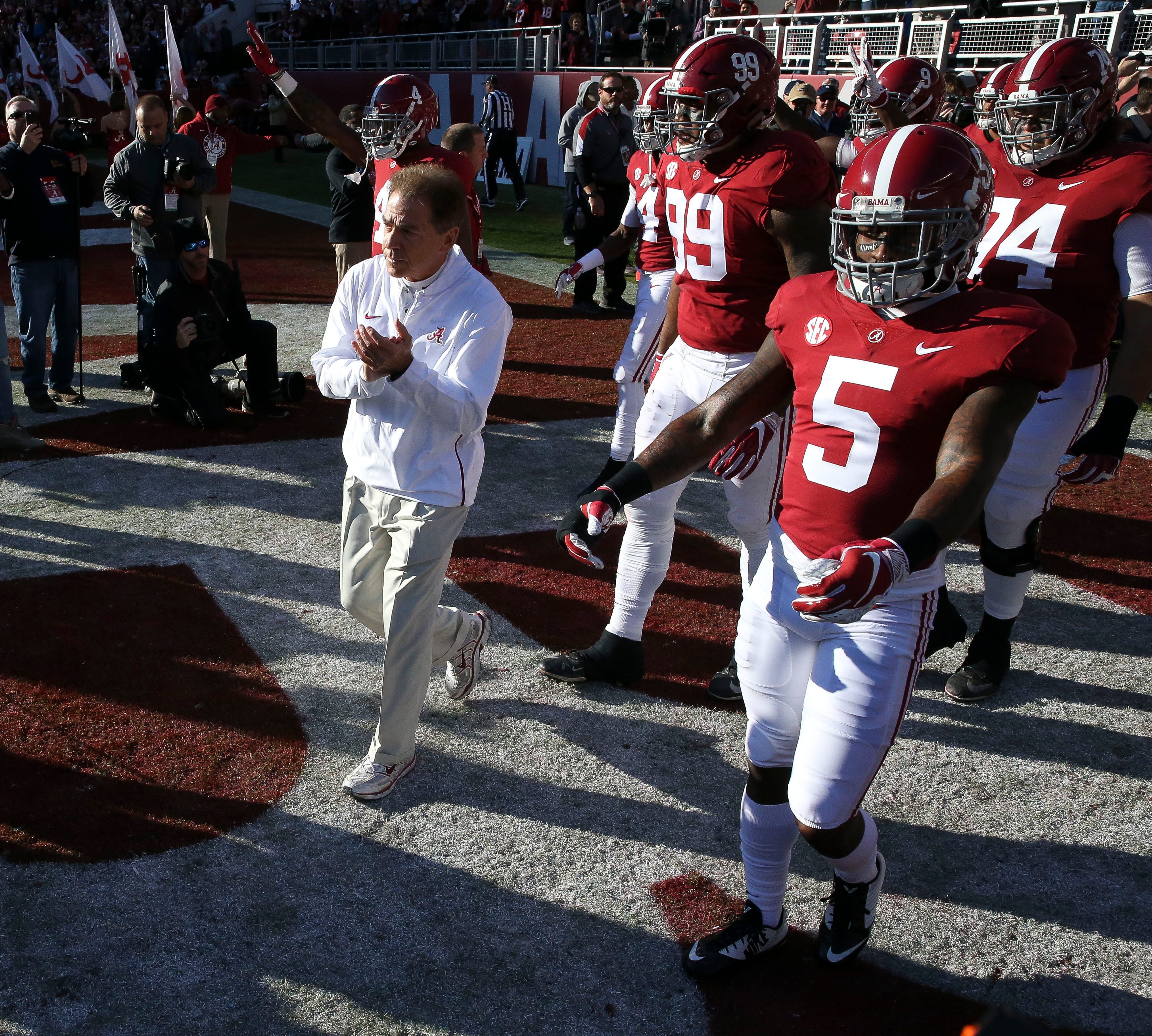 Nick Saban leads the Alabama football team onto the field. The University of Alabama has decided to rename the field in honor of Saban.