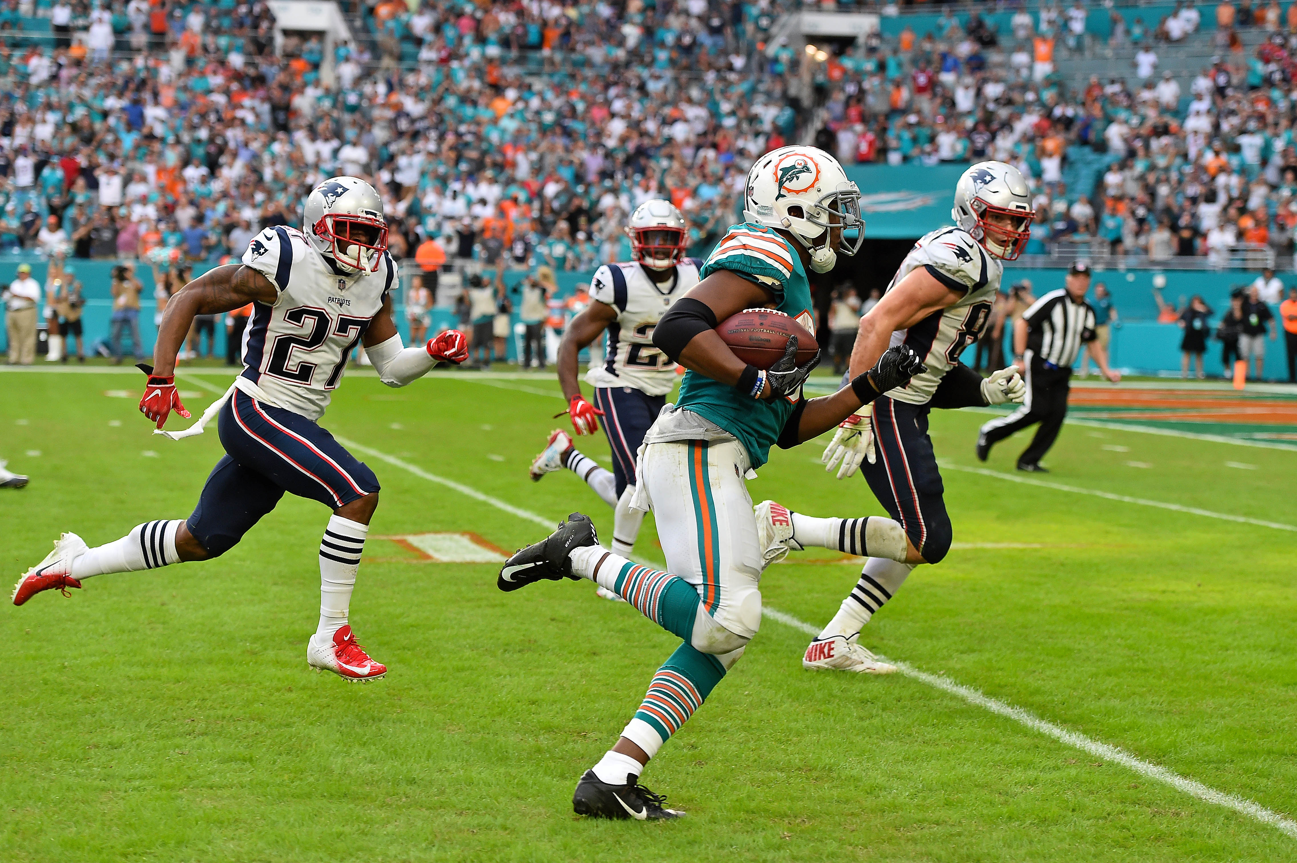 Dec 9, 2018; Miami Gardens, FL, USA; Miami Dolphins running back Kenyan Drake (32) runs the ball after a lateral play to score a touchdown to defeat the New England Patriots at Hard Rock Stadium.