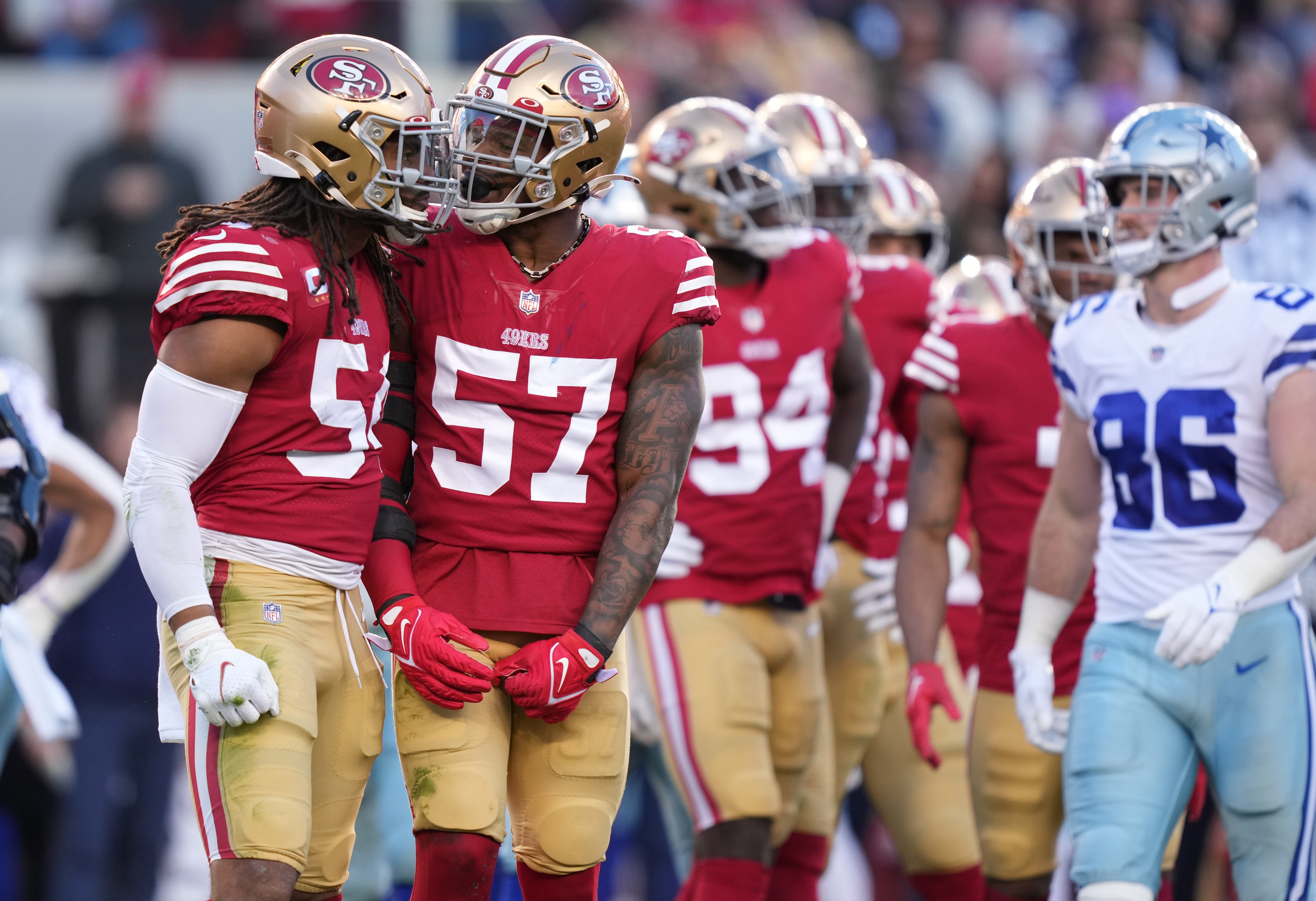 Jan 22, 2023; Santa Clara, California, USA; San Francisco 49ers linebacker Fred Warner (54) and linebacker Dre Greenlaw (57) celebrate after a stop during the first quarter of a NFC divisional round game against the Dallas Cowboys at Levi's Stadium.