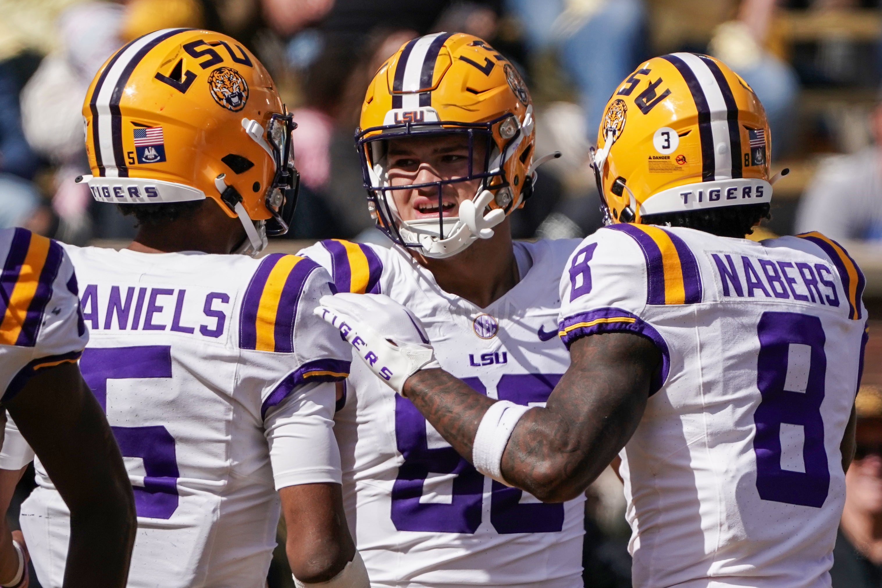 Oct 7, 2023; Columbia, Missouri, USA; LSU Tigers tight end Mason Taylor (86) celebrates with quarterback Jayden Daniels (5) and wide receiver Malik Nabers (8) after scoring against the Missouri Tigers during the first half at Faurot Field at Memorial Stadium.