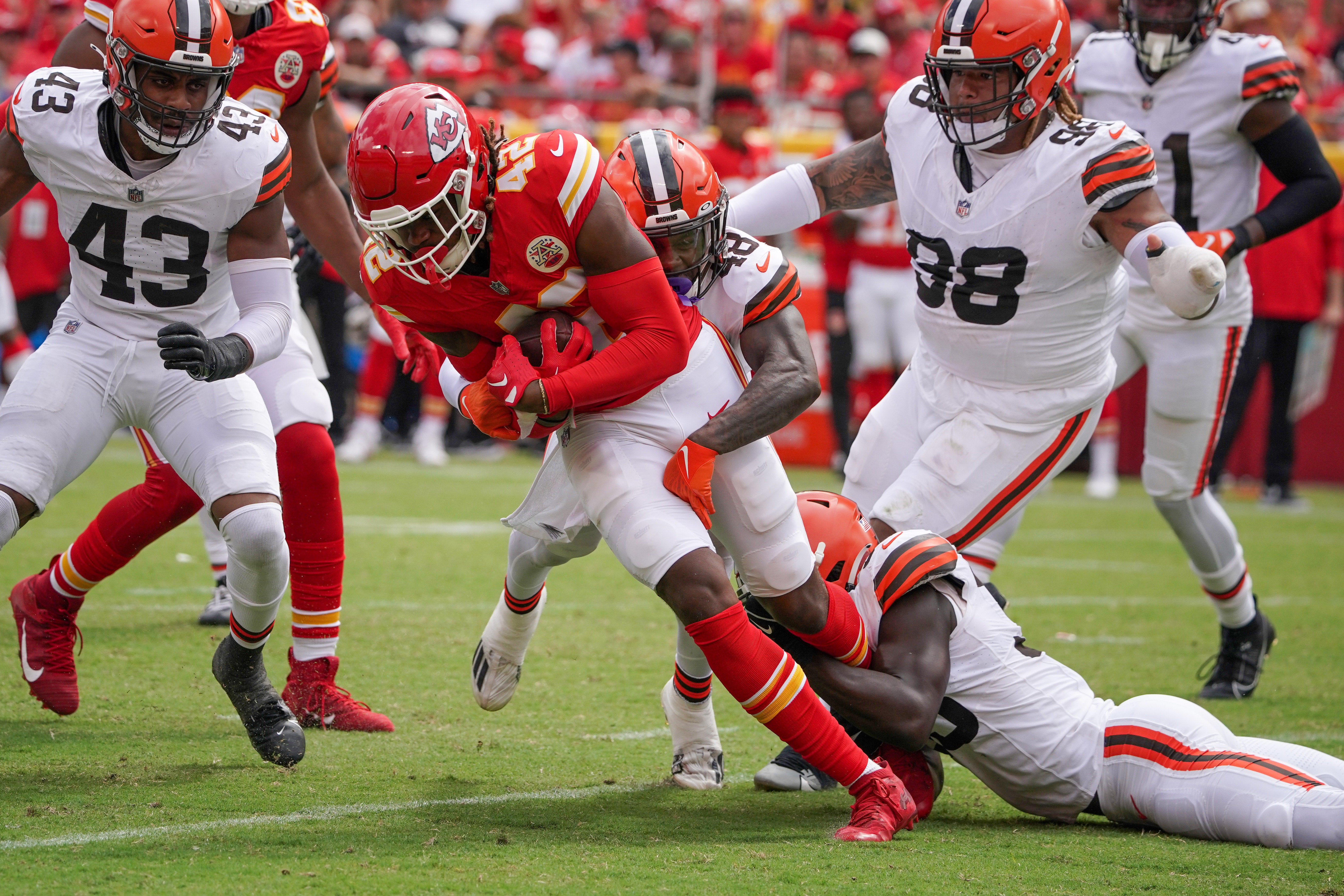 Aug 26, 2023; Kansas City, Missouri, USA; Kansas City Chiefs tight end Izaiah Gathings (42) is tackled by Cleveland Browns safety Tanner McCalister (48) during the second half at GEHA Field at Arrowhead Stadium.