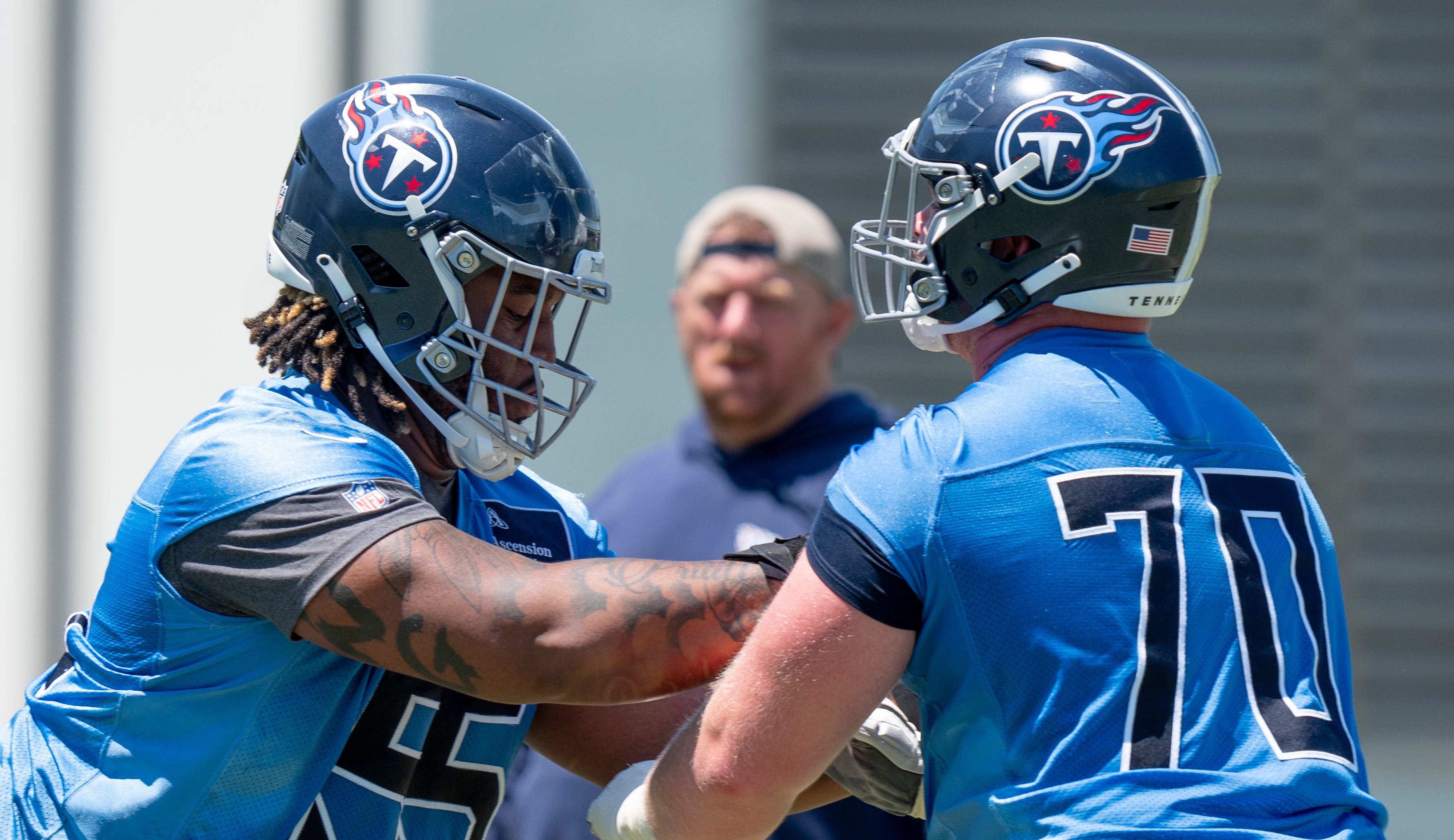 Offensivle lineman JC Latham (55) and Cole Spencer (70) run drills during Tennessee Titans practice at Ascension Saint Thomas Sports Park in Nashville, Tenn., Tuesday, May 21, 2024 Denny Simmons / The Tennessean-USA TODAY NETWORK