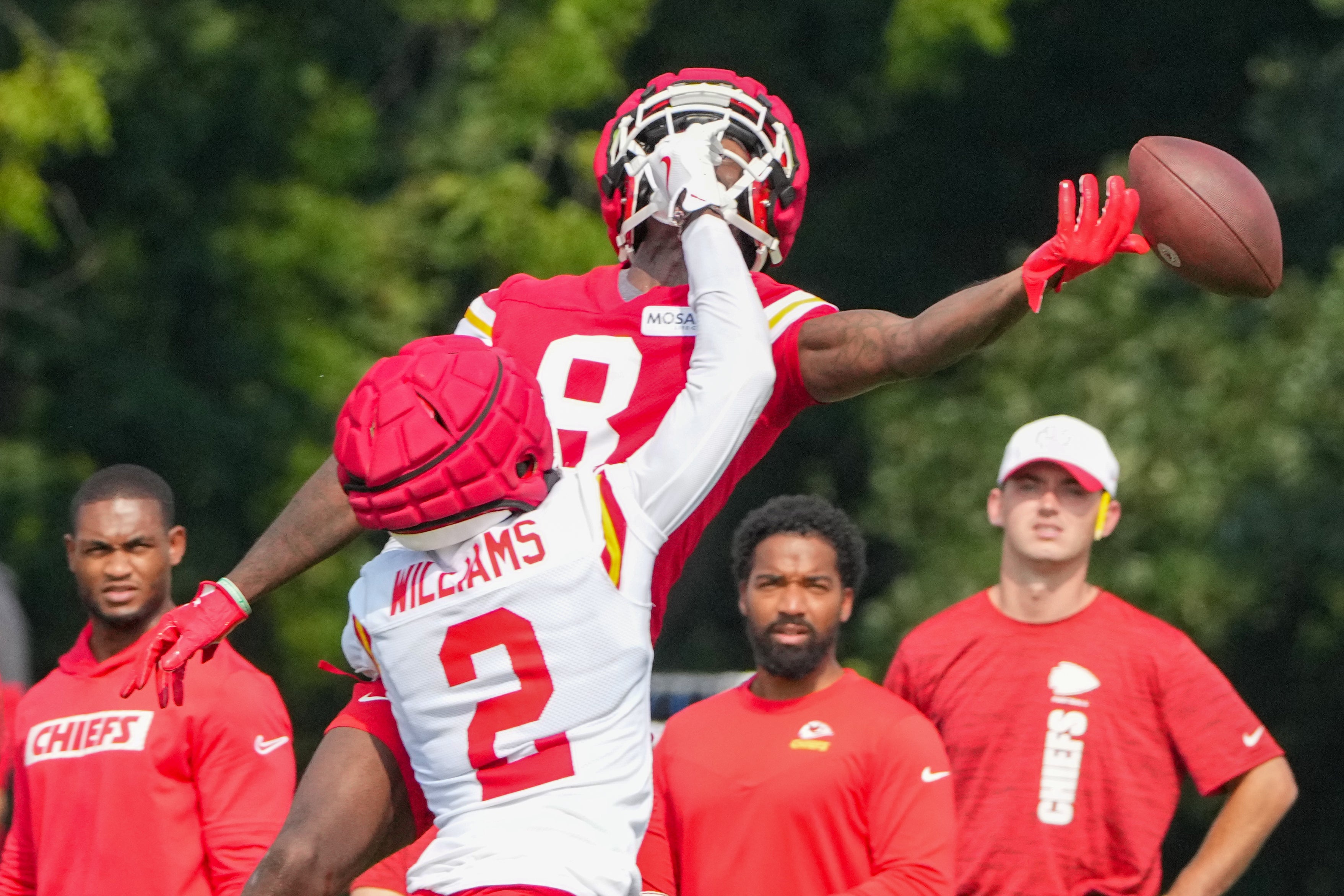 Jul 22, 2024; St. Joseph, MO, USA; Kansas City Chiefs wide receiver Justyn Ross (8) drops a pass against cornerback Joshua Williams (2) during training camp at Missouri Western State University.