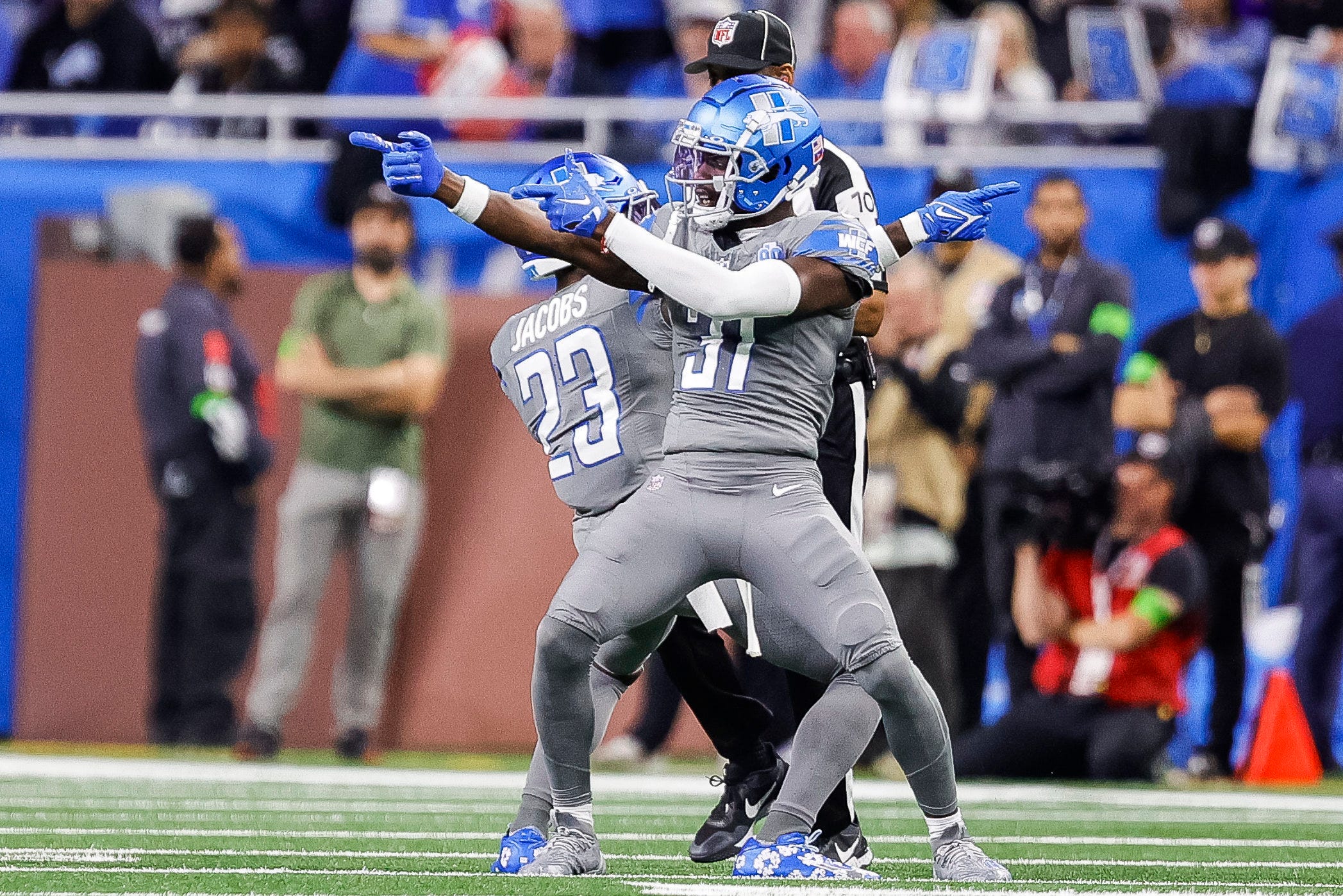 Lions cornerback Jerry Jacobs, left, and safety Kerby Joseph celebrate a play against the Raiders during the first half at Ford Field on Monday, Oct. 30, 2023.