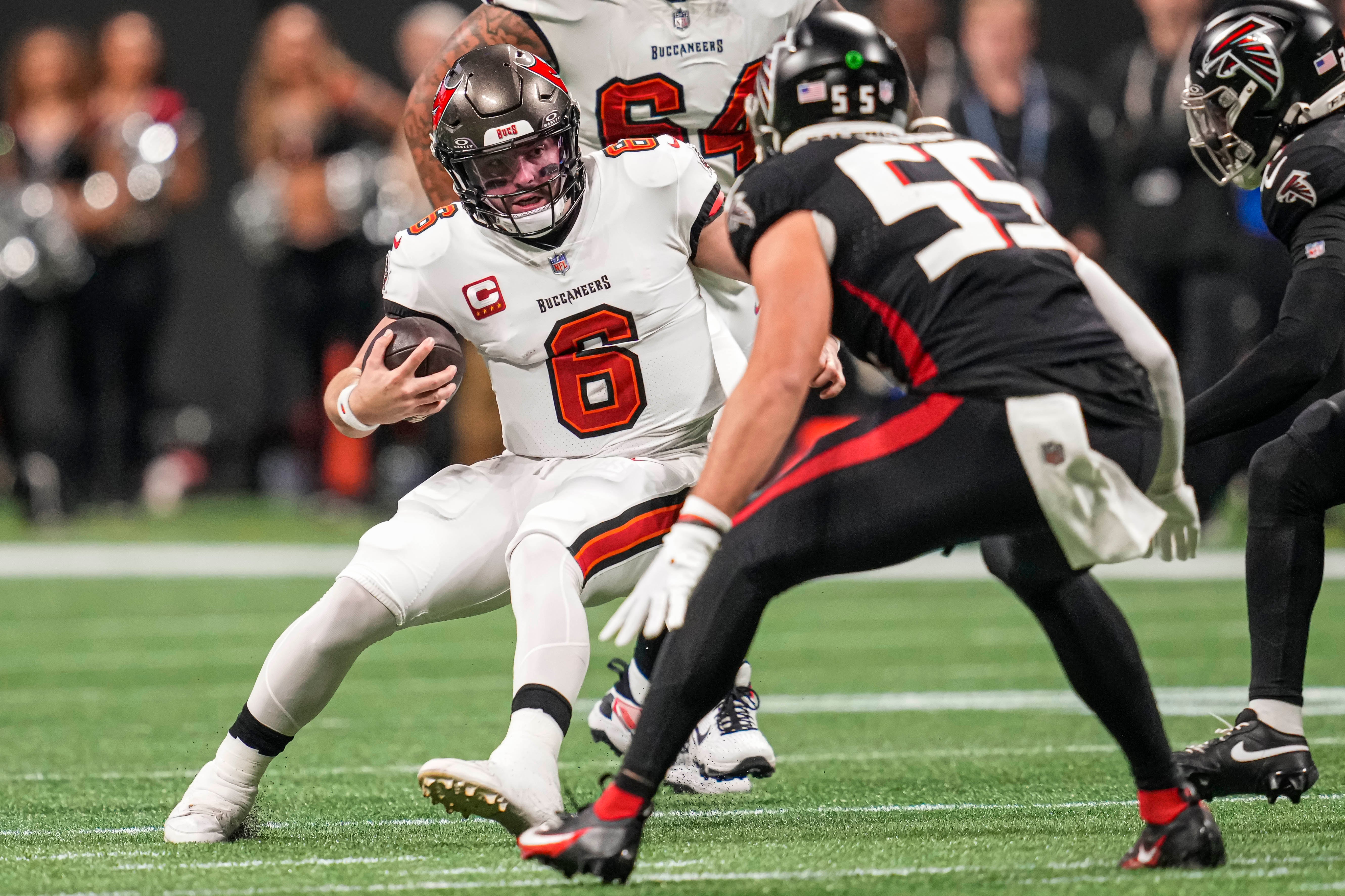Buccaneers quarterback Baker Mayfield runs against Falcons linebacker Kaden Elliss.
