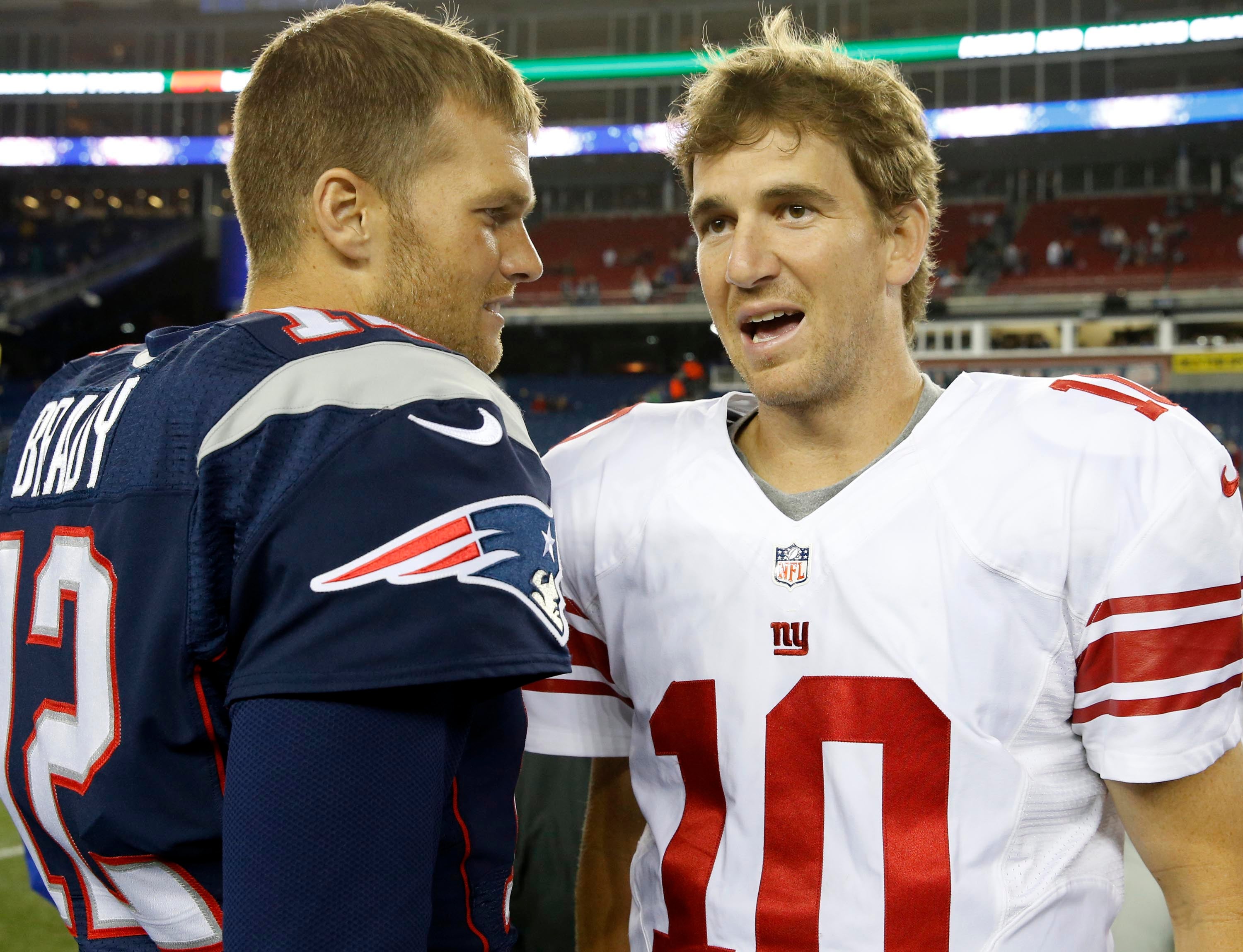 Aug 29, 2013; Foxborough, MA, USA; New England Patriots quarterback Tom Brady (12) and New York Giants quarterback Eli Manning (10) meet on the field after the game Gillette Stadium. The Patriots defeated the Giants 28-20.