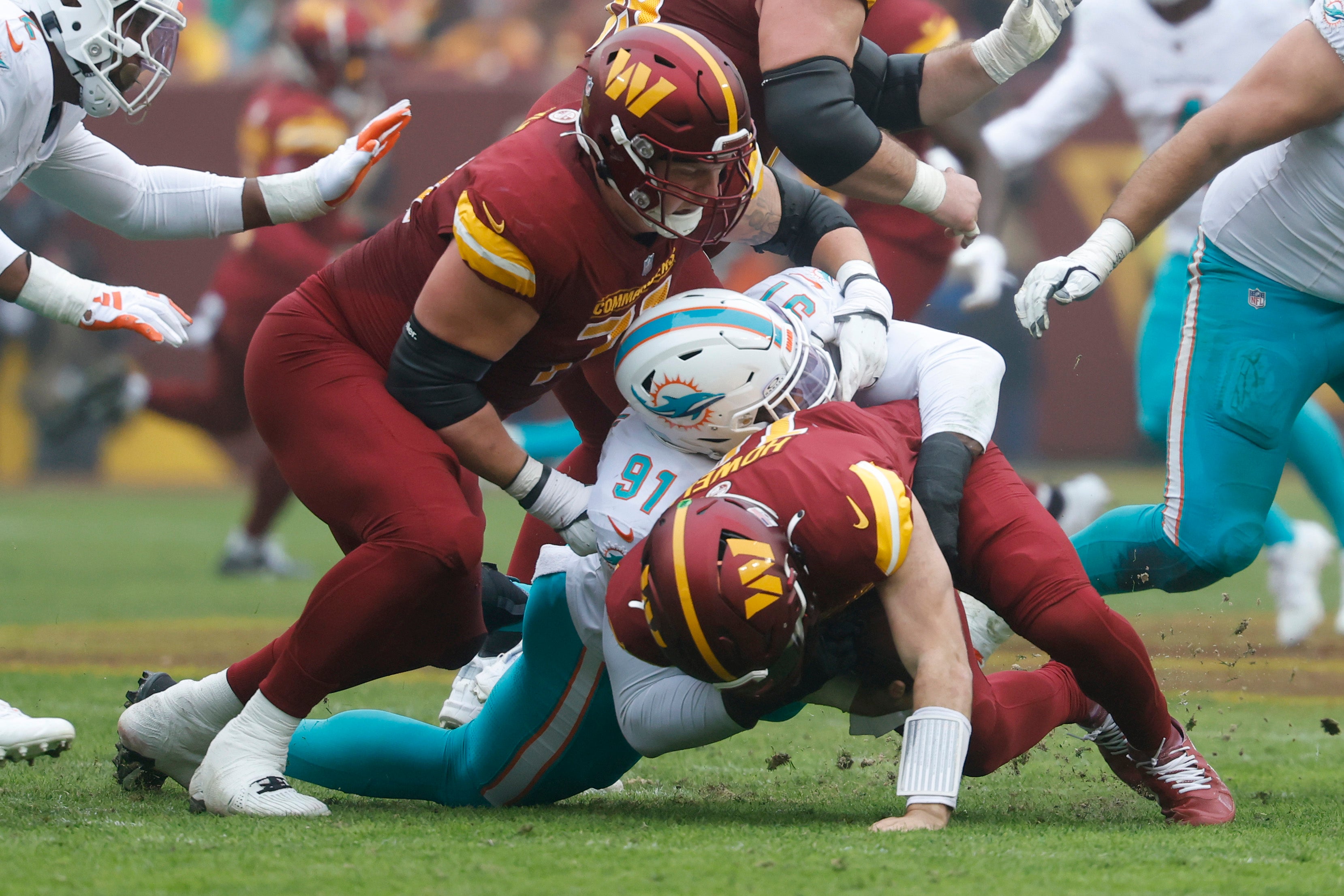 Dec 3, 2023; Landover, Maryland, USA; Miami Dolphins defensive end Emmanuel Ogbah (91) sacks Washington Commanders quarterback Sam Howell (14) during the first quarter at FedExField.