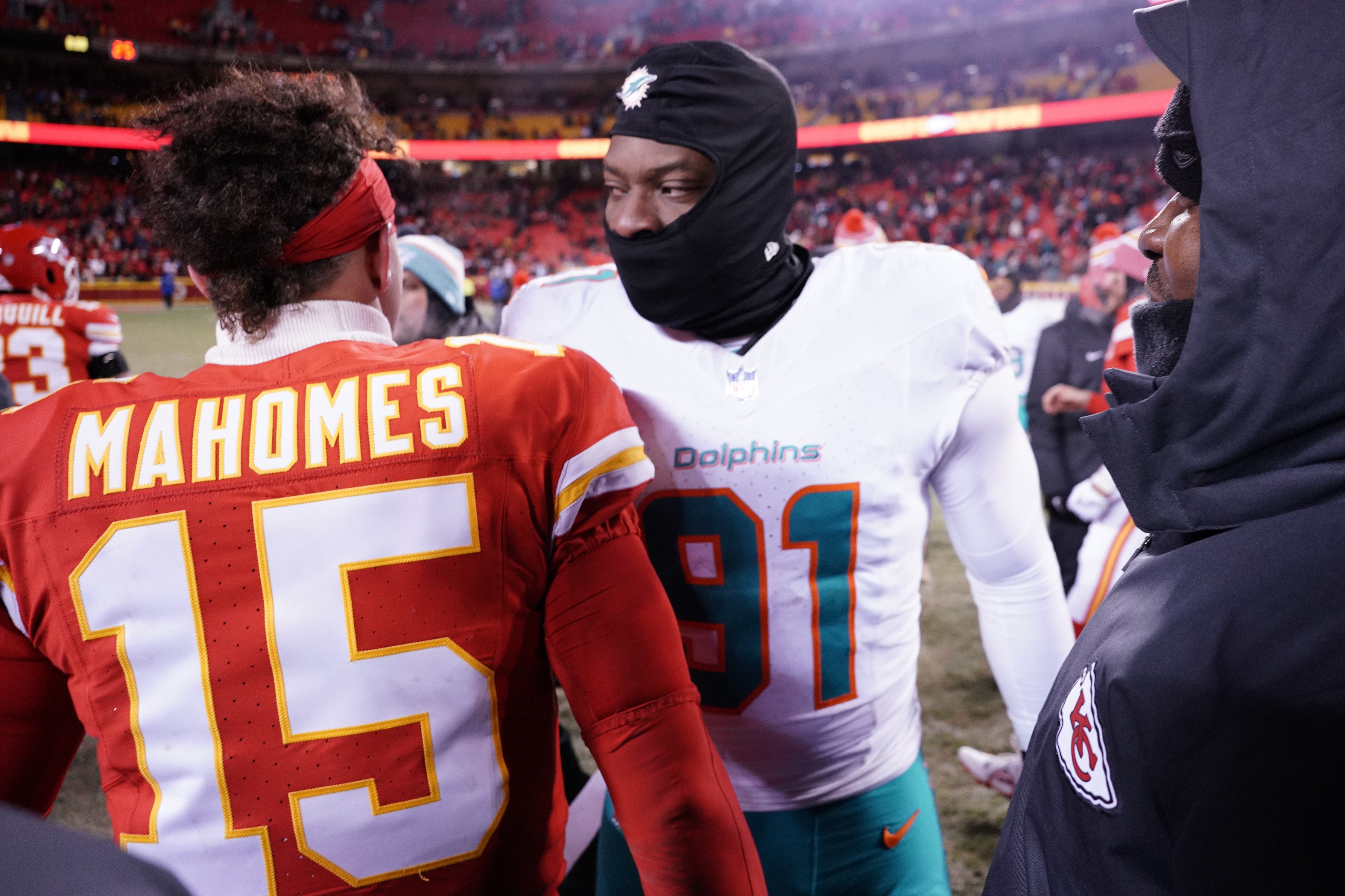 Jan 13, 2024; Kansas City, Missouri, USA; Kansas City Chiefs quarterback Patrick Mahomes (15) meets with Miami Dolphins defensive end Emmanuel Ogbah (91) following the 2024 AFC wild card game at GEHA Field at Arrowhead Stadium.