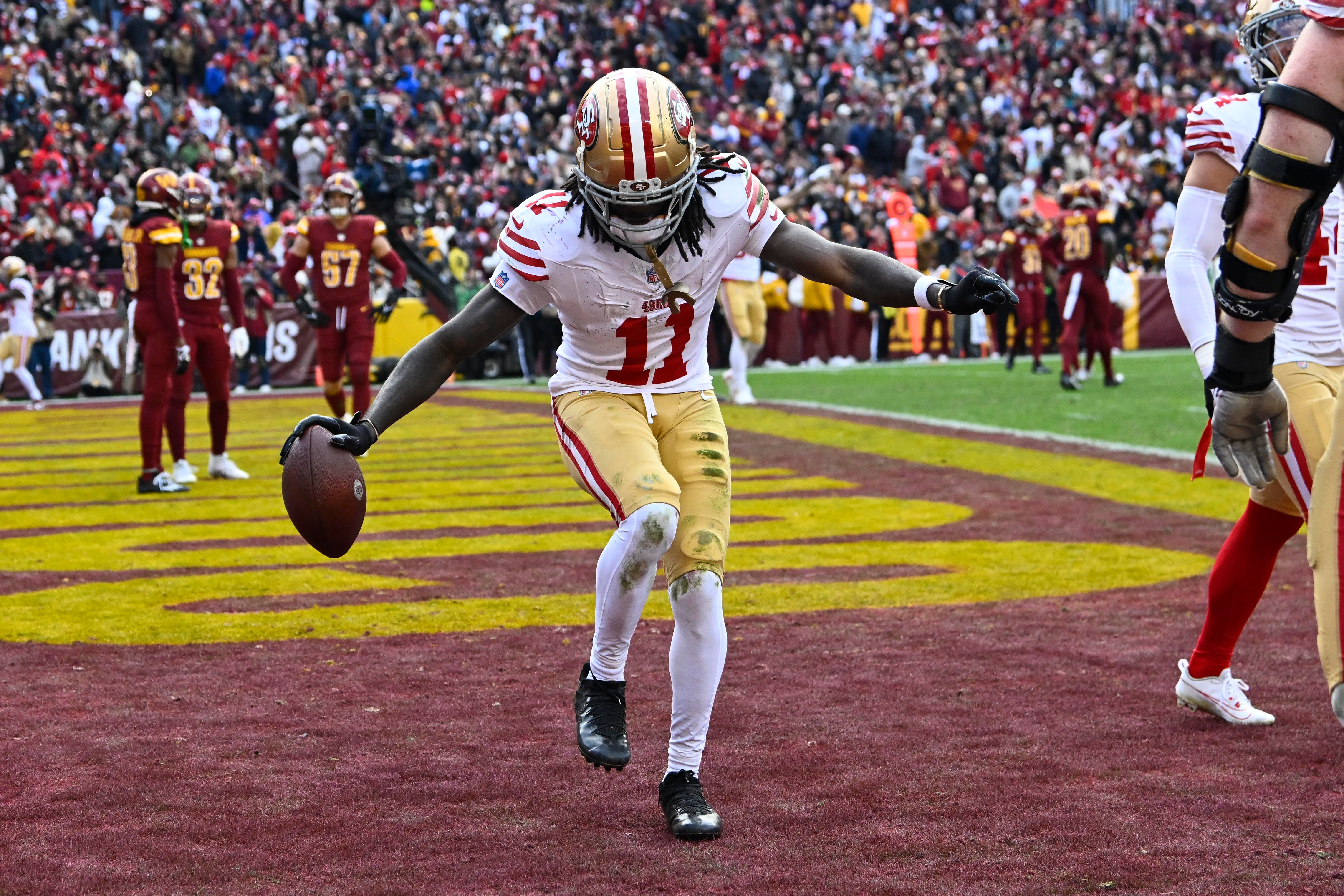 Dec 31, 2023; Landover, Maryland, USA; San Francisco 49ers wide receiver Brandon Aiyuk (11) celebrates after scoring a touchdown against the Washington Commanders during the second half at FedExField. 