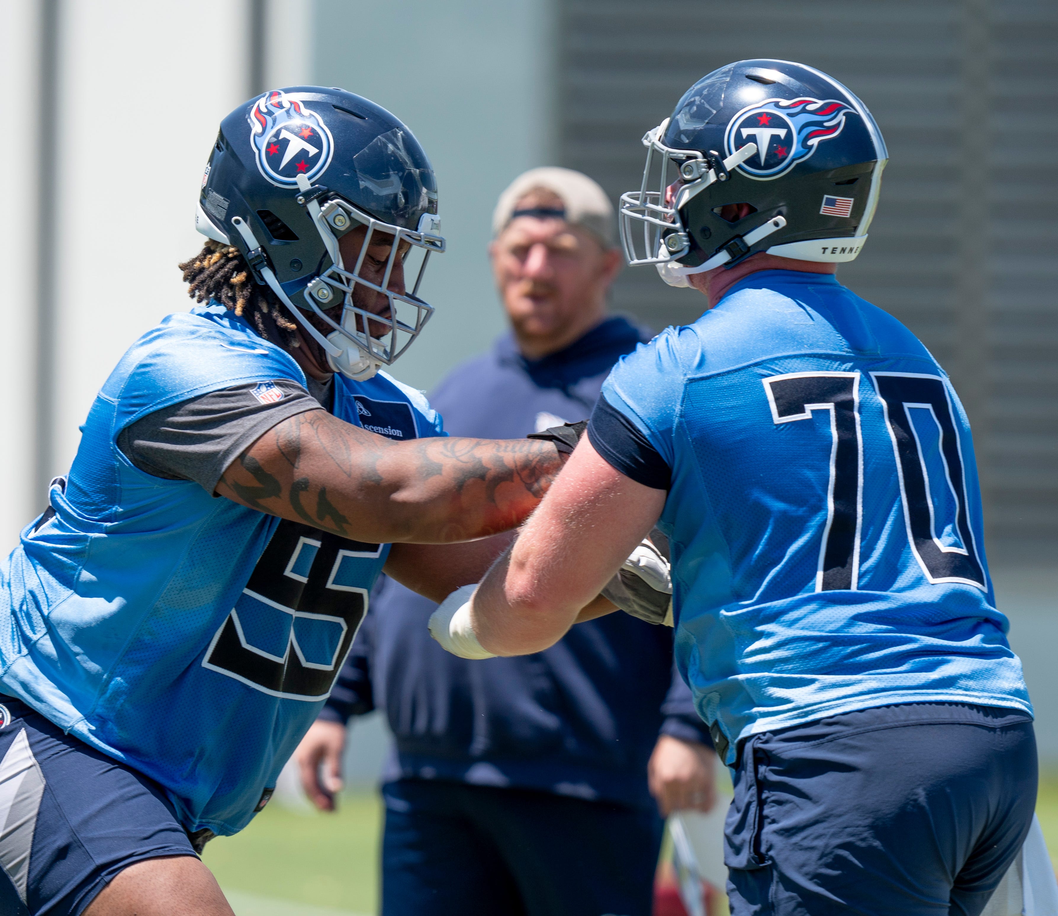 Offensivle lineman JC Latham (55) and Cole Spencer (70) run drills during Tennessee Titans practice at Ascension Saint Thomas Sports Park in Nashville, Tenn., Tuesday, May 21, 2024.
