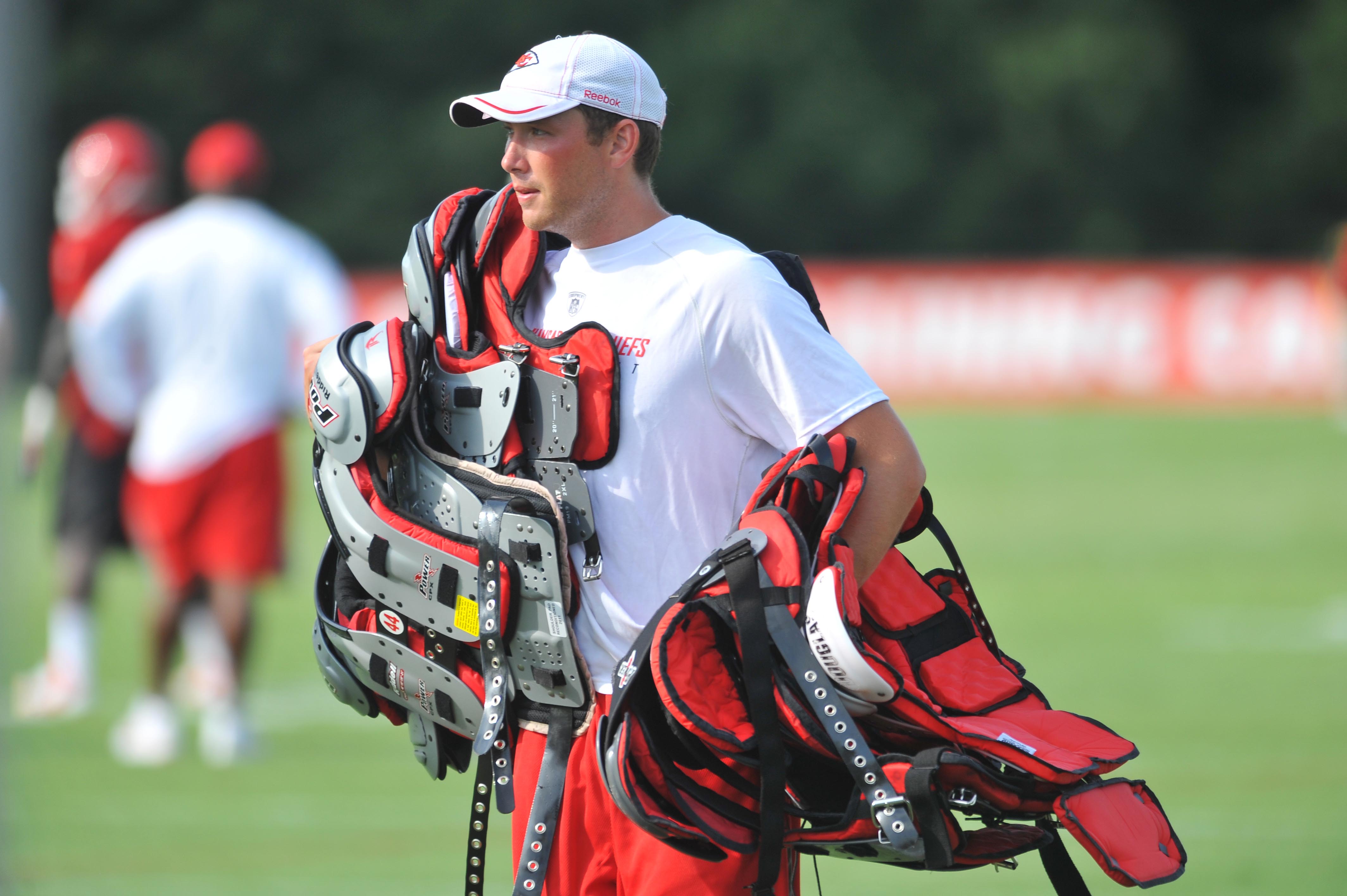Aug 04, 2011; St. Joseph, MO, USA; A camp assistant loads up on shoulder pads during training camp at Missouri Western State University. Mandatory Credit: Denny Medley-USA TODAY Sports  
