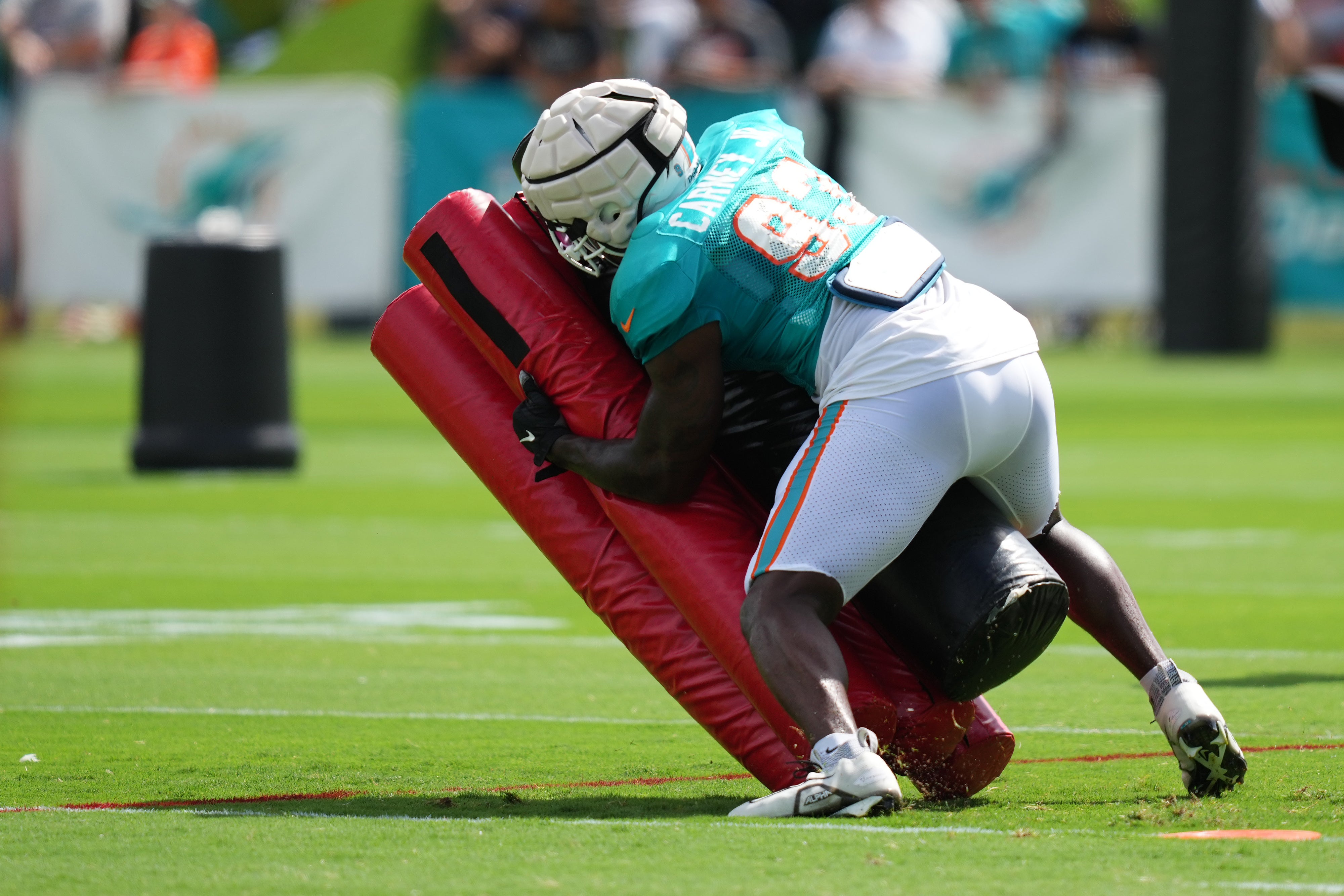 Aug 2, 2022; Miami Gardens, Florida, US; Miami Dolphins defensive lineman Owen Carney Jr. (93) runs a drill during training camp at Baptist Health Training Complex.
