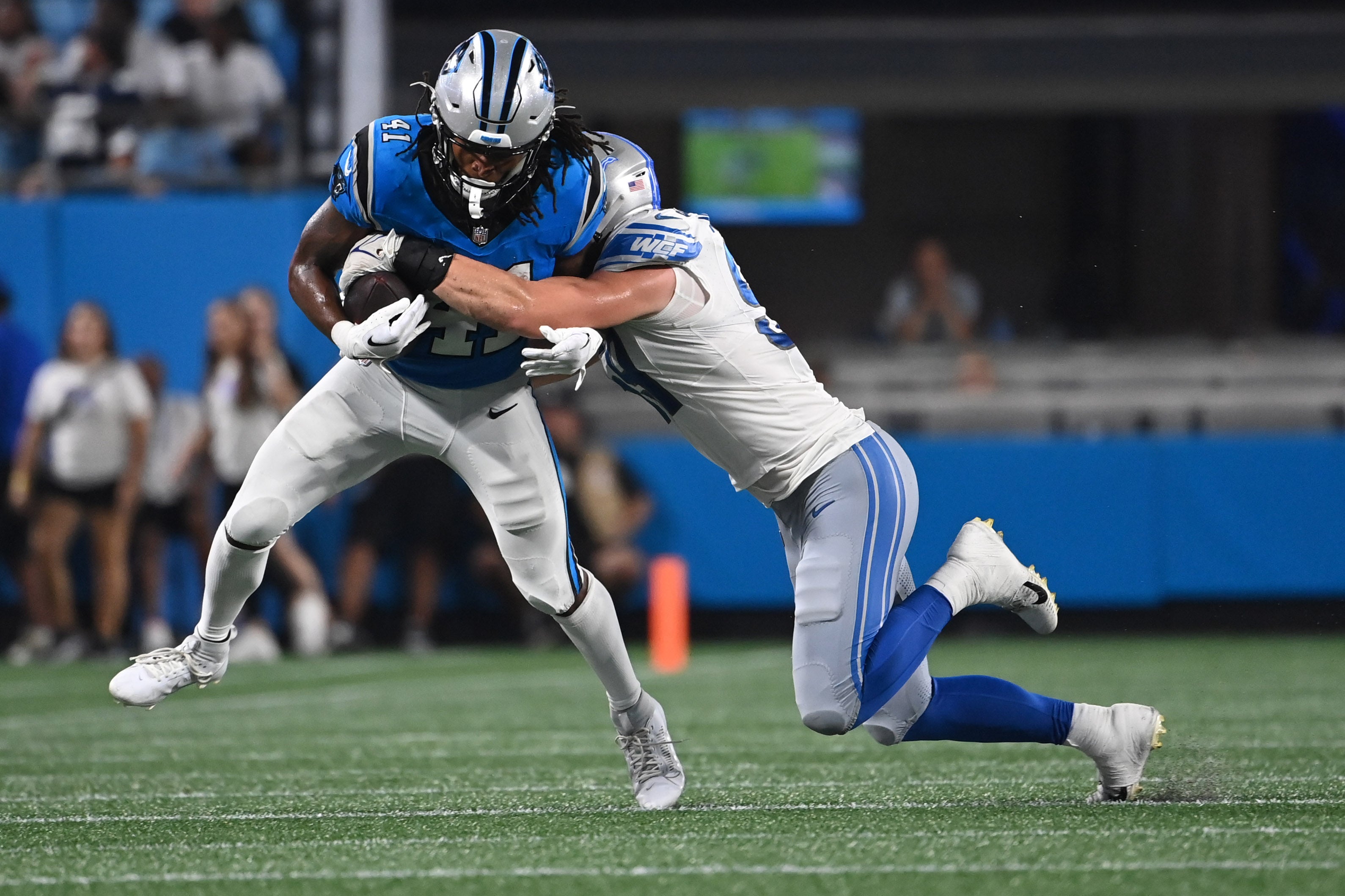 Aug 25, 2023; Charlotte, North Carolina, USA; Carolina Panthers running back Spencer Brown (41) with the ball as Detroit Lions linebacker Trevor Nowaske (59) defends in the second quarter at Bank of America Stadium.