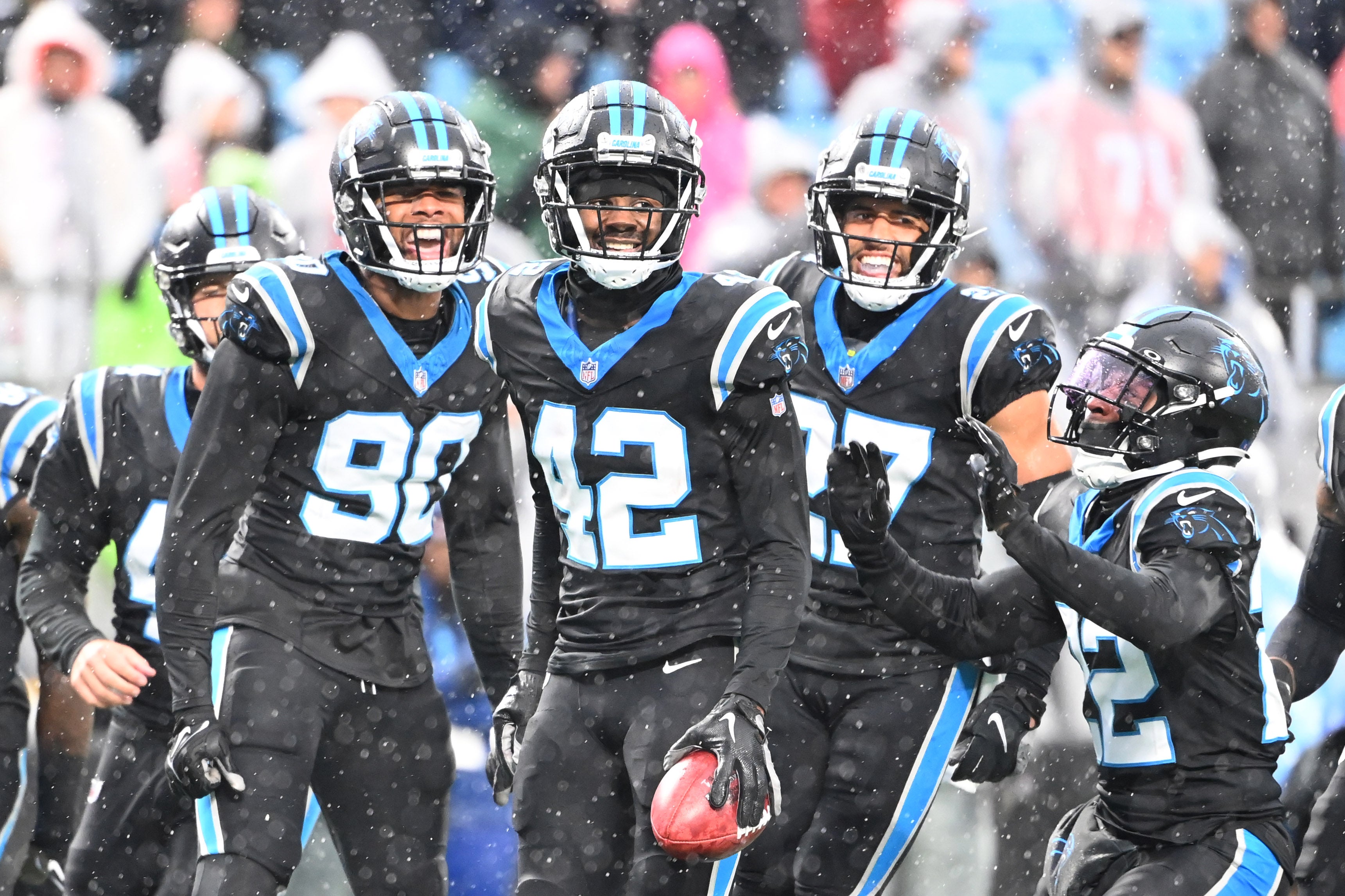 Dec 17, 2023; Charlotte, North Carolina, USA; Carolina Panthers special teams players linebacker Amare Barno (90) and safeties Sam Franklin Jr. (42) and Alex Cook (27) and Jammie Robinson (22) react in the first quarter at Bank of America Stadium. Mandatory Credit: Bob Donnan-USA TODAY Sports