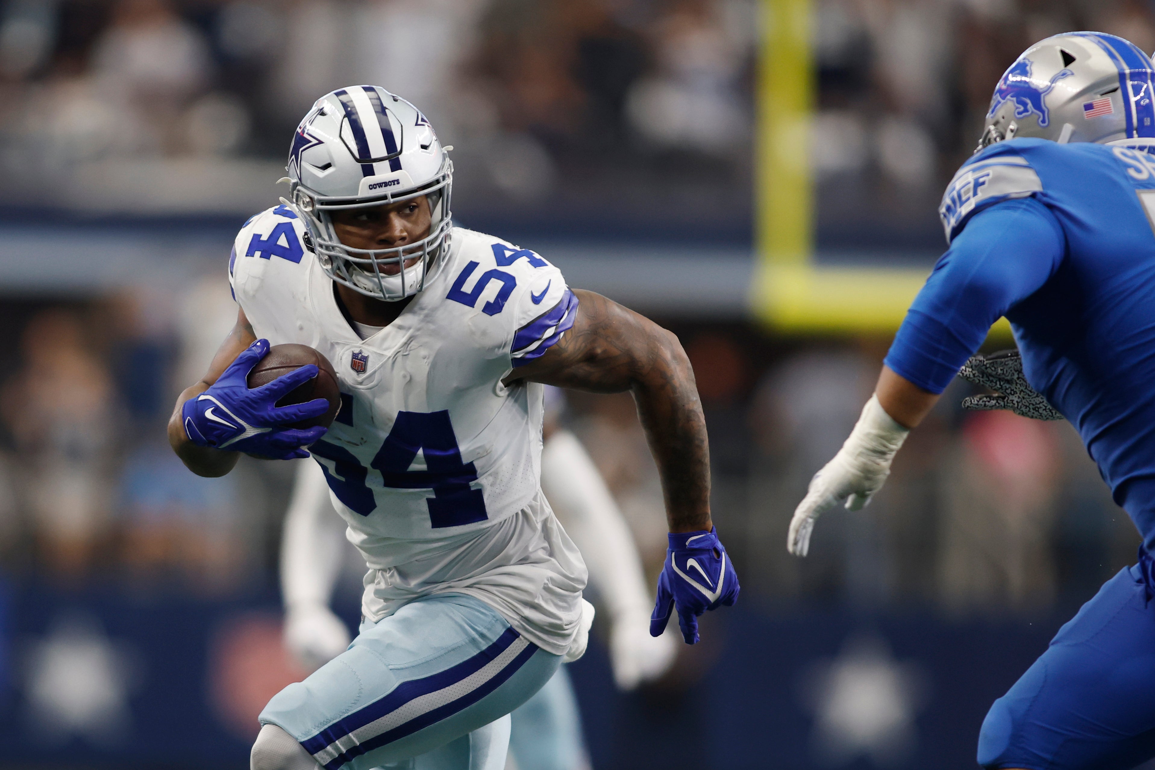 Dallas Cowboys defensive end Sam Williams (54) runs with the ball after recovering a fumble in the fourth quarter against the Detroit Lions at AT&T Stadium.