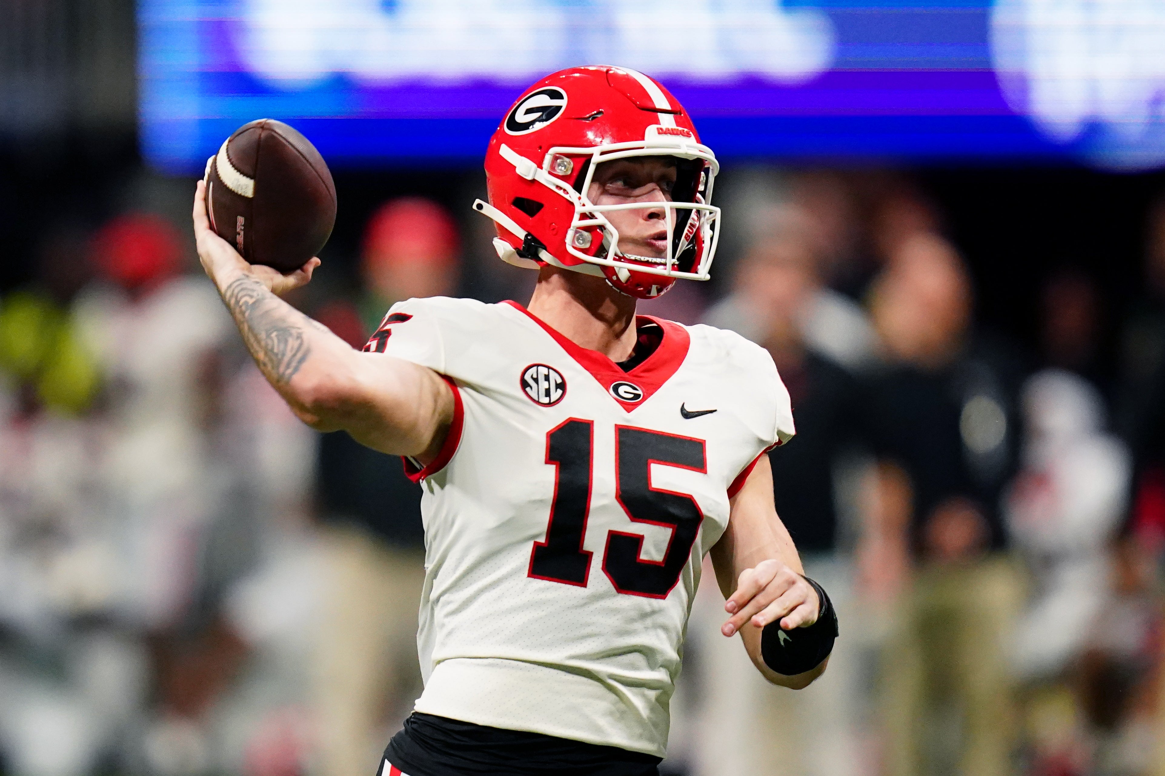 Georgia Bulldogs quarterback Carson Beck (15) throws a pass against the Alabama Crimson Tide in the third quarter of the SEC Championship at Mercedes-Benz Stadium.