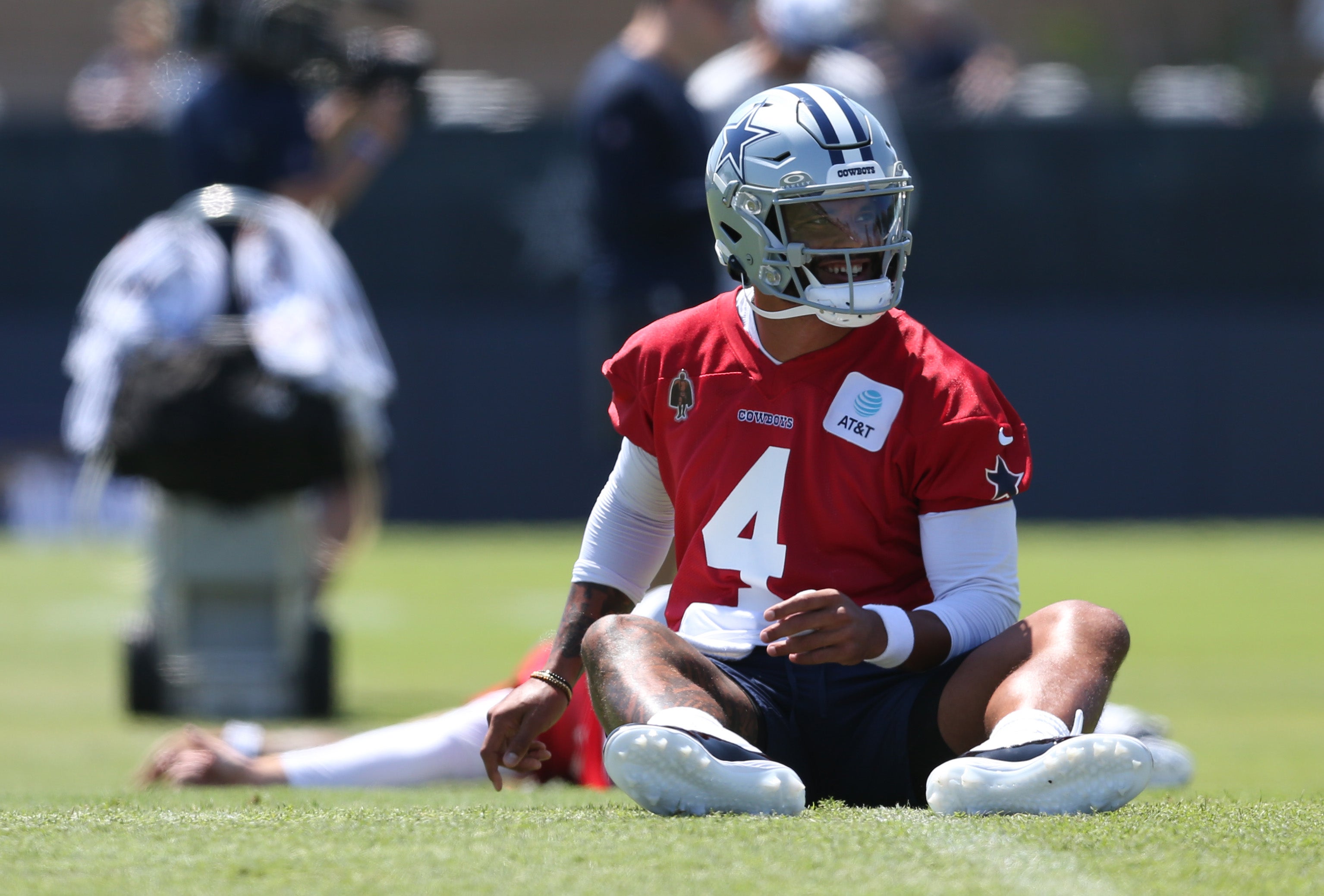 Dallas Cowboys quarterback Dak Prescott (4) stretches during training camp at the River Ridge Playing Fields in Oxnard, Californian.