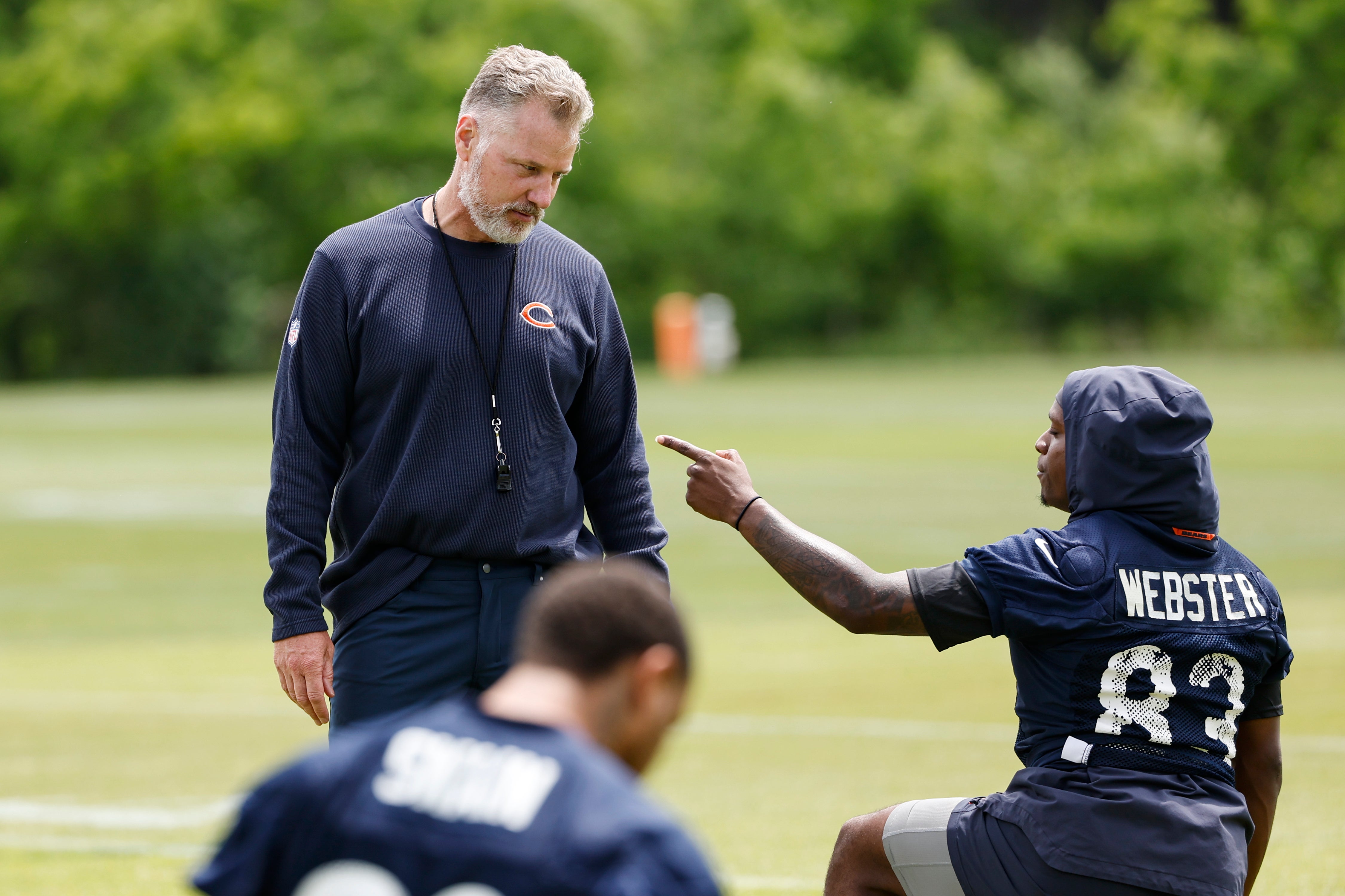 Jun 5, 2024; Lake Forest, IL, USA; Chicago Bears head coach Matt Eberflus talks with Chicago Bears wide receiver Nsimba Webster (83) during the team's minicamp at Halas Hall.