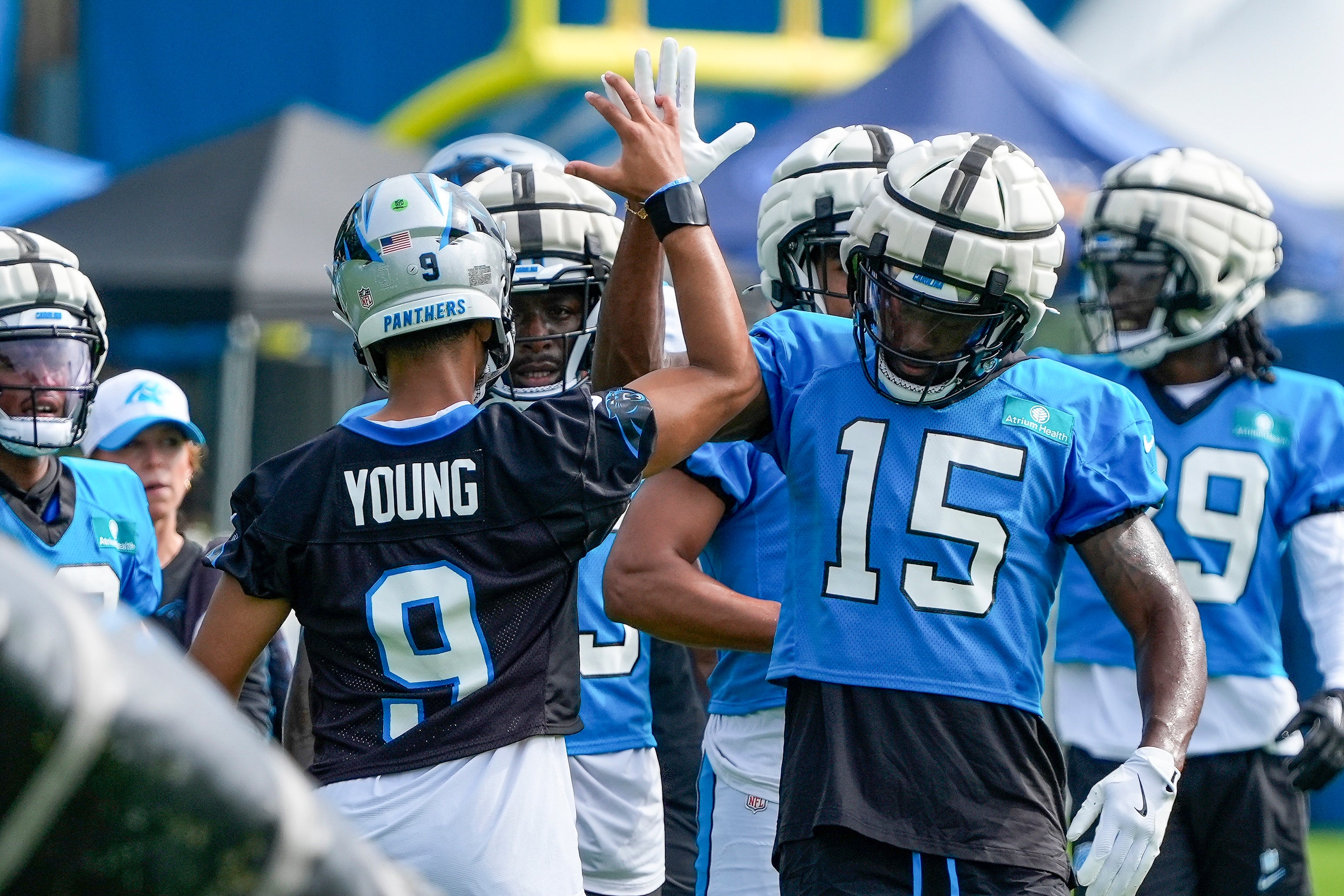 Jul 24, 2024; Charlotte, NC, USA; Carolina Panthers quarterback Bryce Young (9) high fives wide receiver Jonathan Mingo (15) at Carolina Panthers Practice Fields. Mandatory Credit: Jim Dedmon-USA TODAY Sports