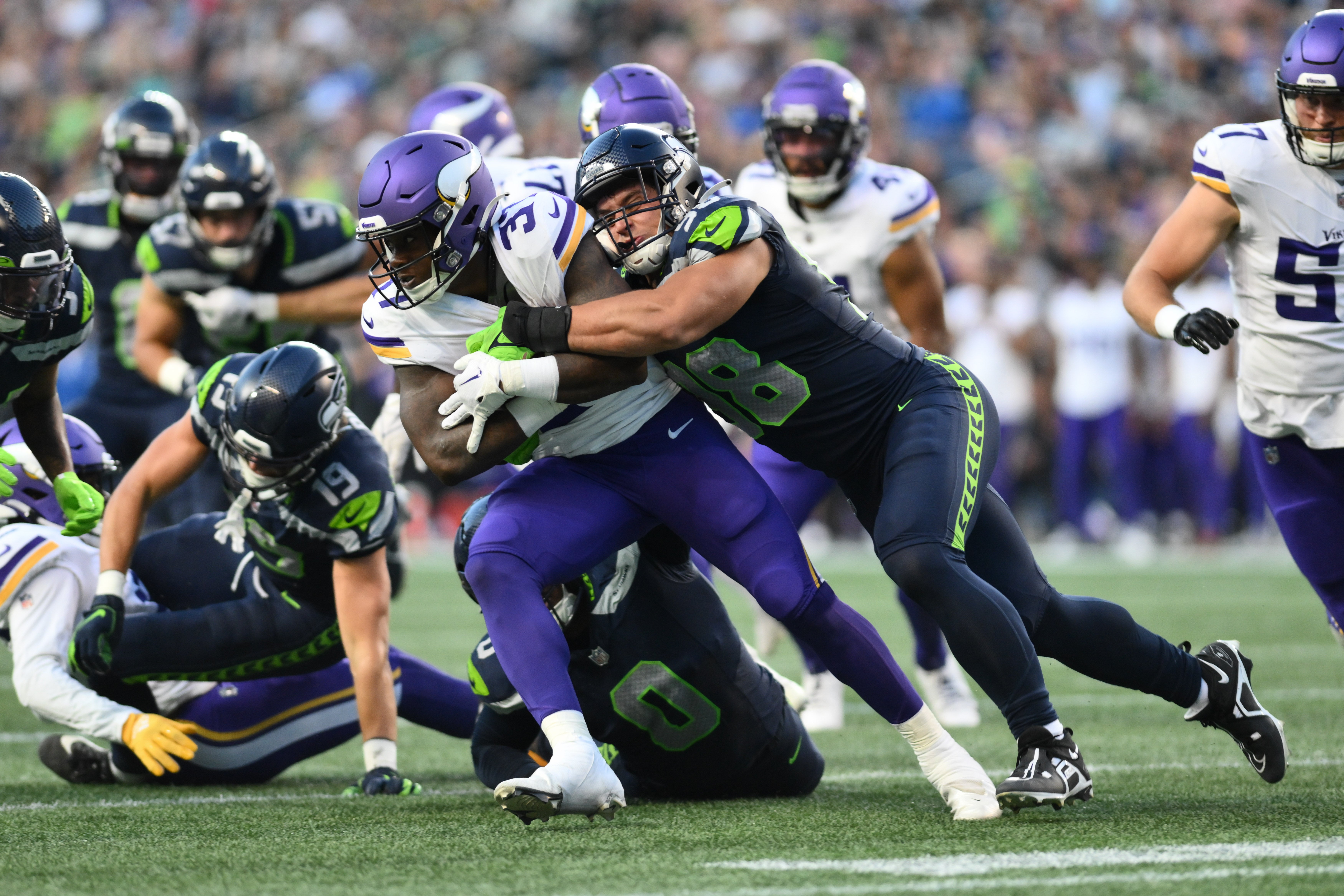 Aug 10, 2023; Seattle, Washington, USA; Seattle Seahawks linebacker Levi Bell (98) tackles Minnesota Vikings running back DeWayne McBride (37) during the first half at Lumen Field.