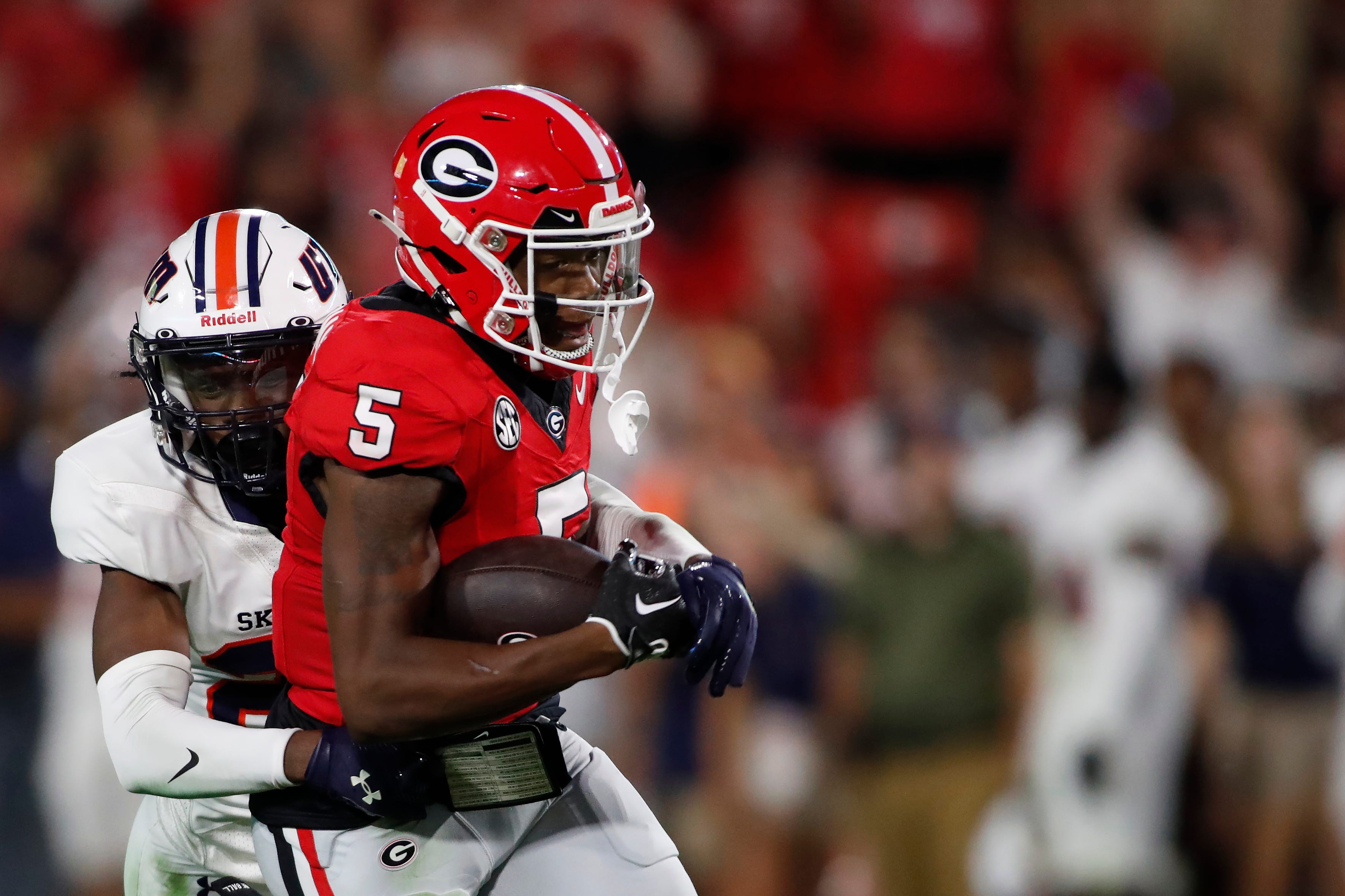 Georgia wide receiver Rara Thomas (5) tries to fight off a tackle from Tennessee Martin safety Antonio Jackson (23) after making a big catch during the second half of a NCAA college football game again.