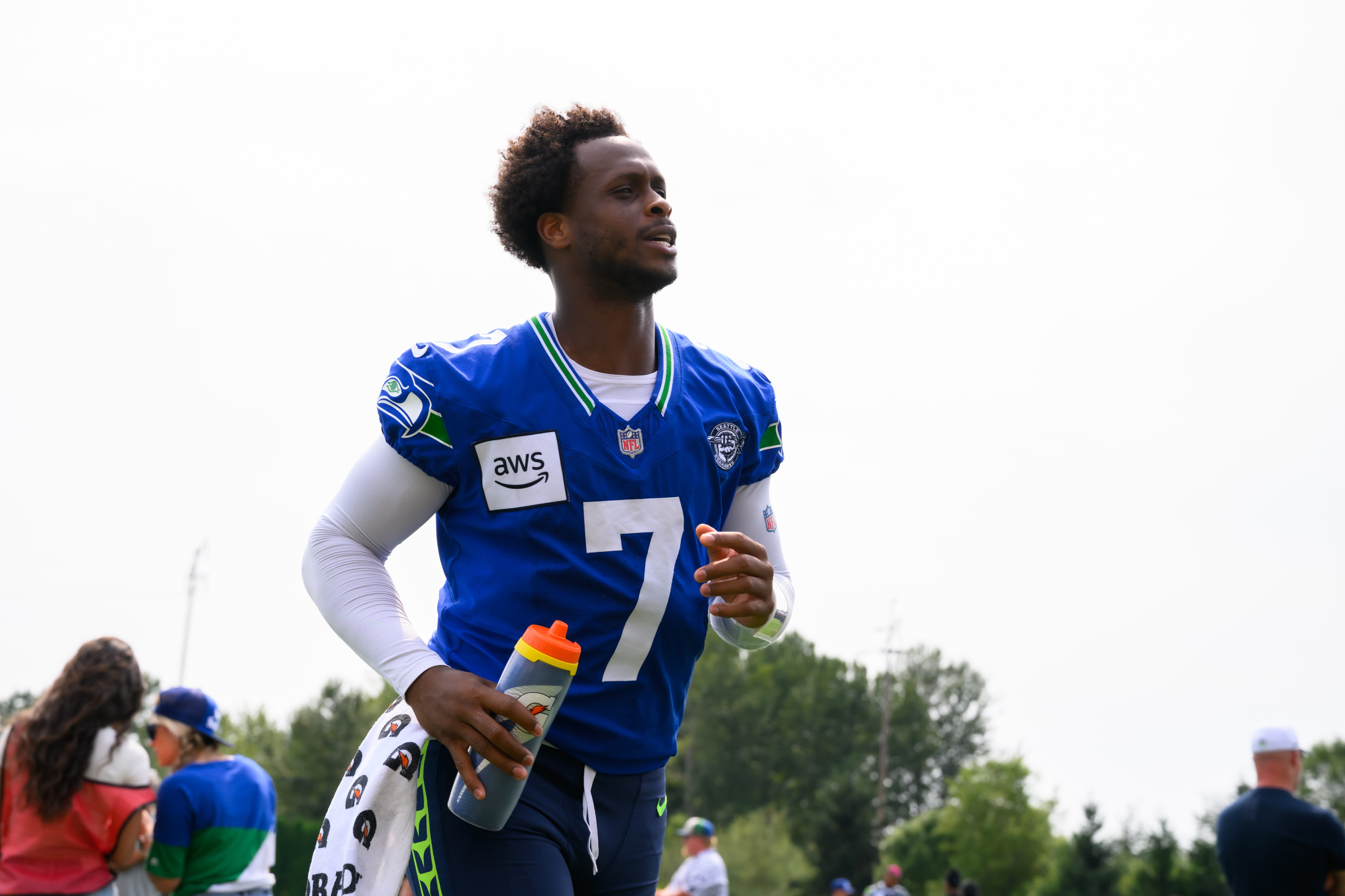 Jul 27, 2024; Renton, WA, USA; Seattle Seahawks quarterback Geno Smith (7) jogs off the field after training camp at Virginia Mason Athletic Center.