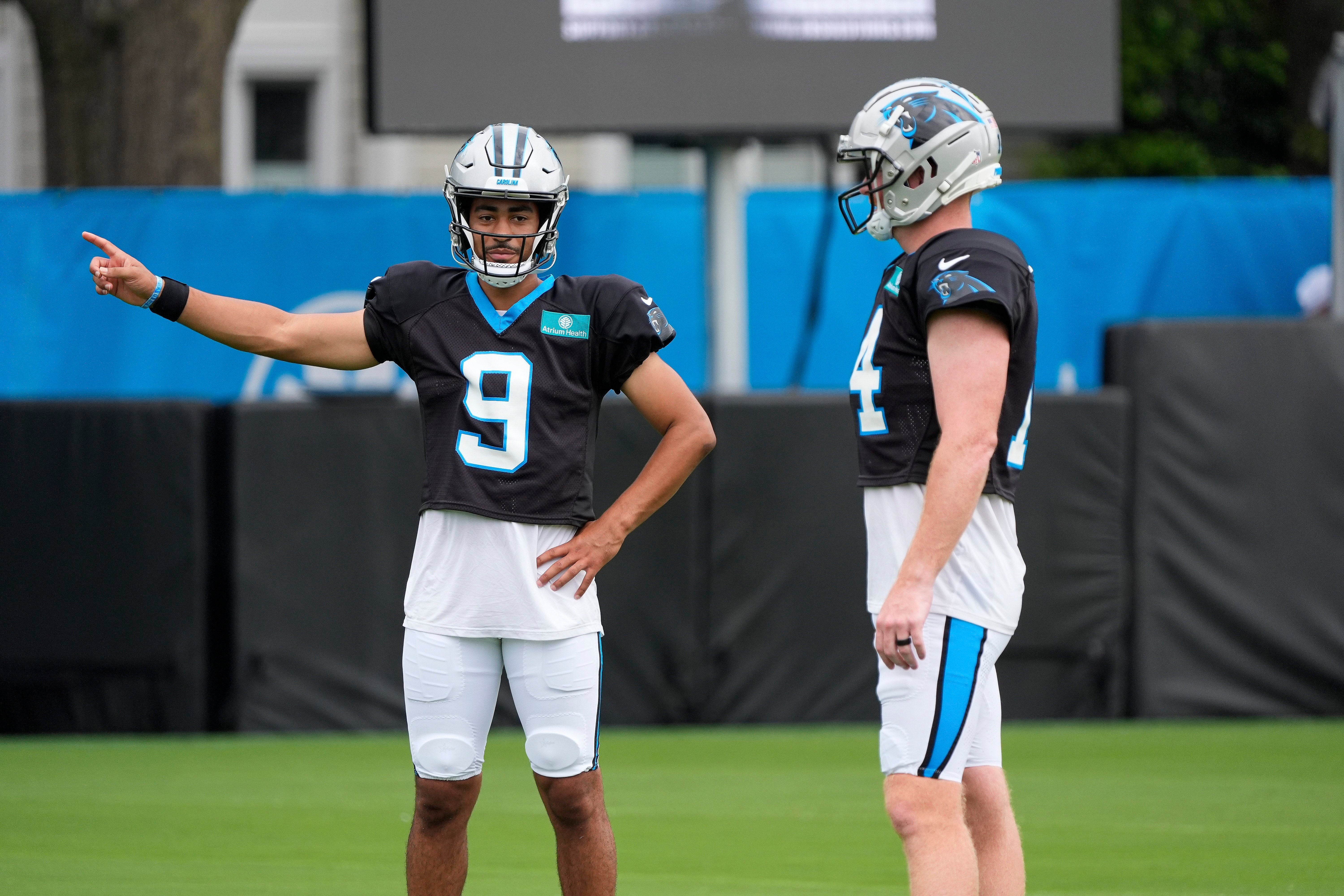 Jul 30, 2024; Charlotte, NC, USA; Carolina Panthers quarterback Bryce Young (9) and quarterback Andy Dalton (14) talk during training camp at Carolina Panthers Practice Fields. Mandatory Credit: Jim Dedmon-USA TODAY Sports