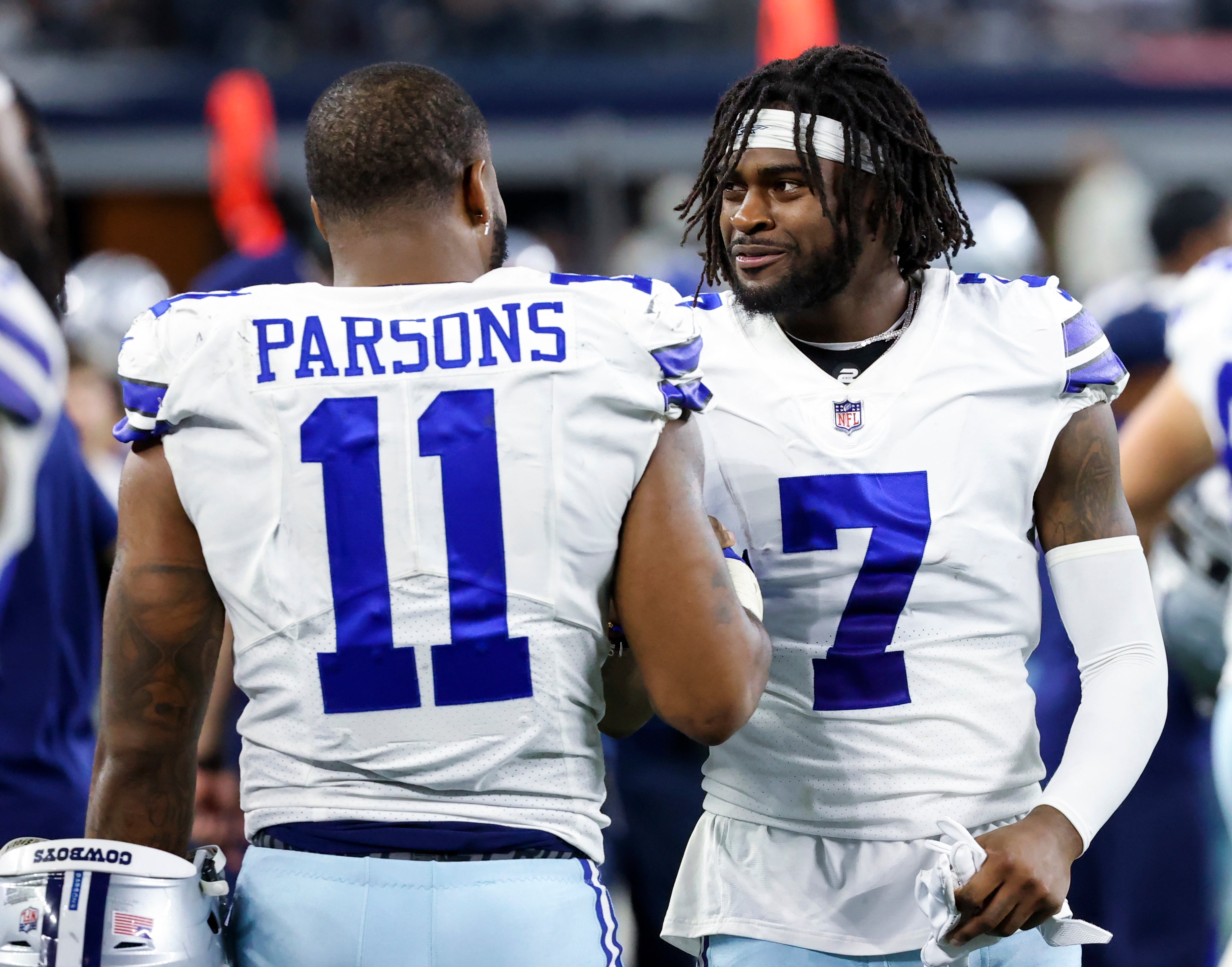 Dallas Cowboys linebacker Micah Parsons (11) and cornerback Trevon Diggs (7) laugh during the game against the Philadelphia Eagles at AT&T Stadium.