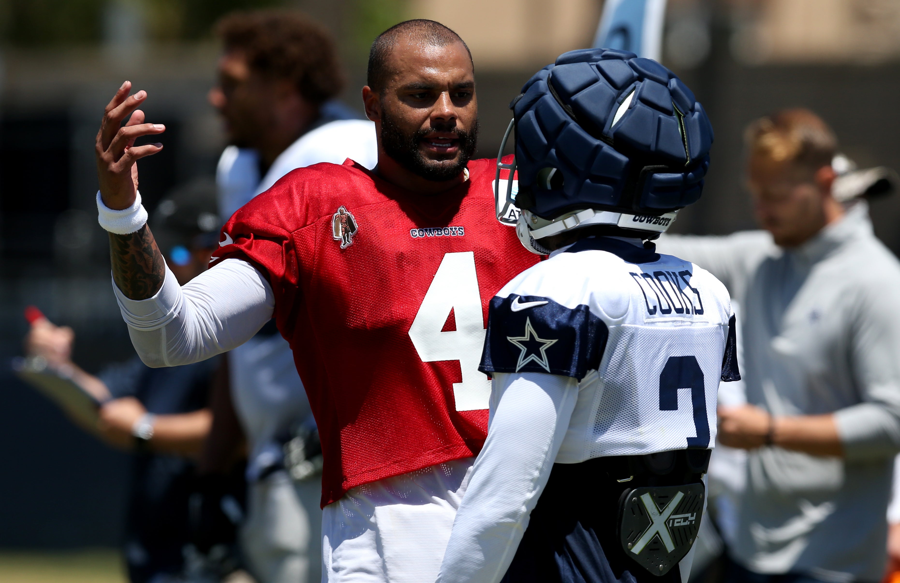 Dallas Cowboys quarterback Dak Prescott (4) talks to wide receiver Brandin Cooks (3) during training camp at the River Ridge Playing Fields in Oxnard, California.