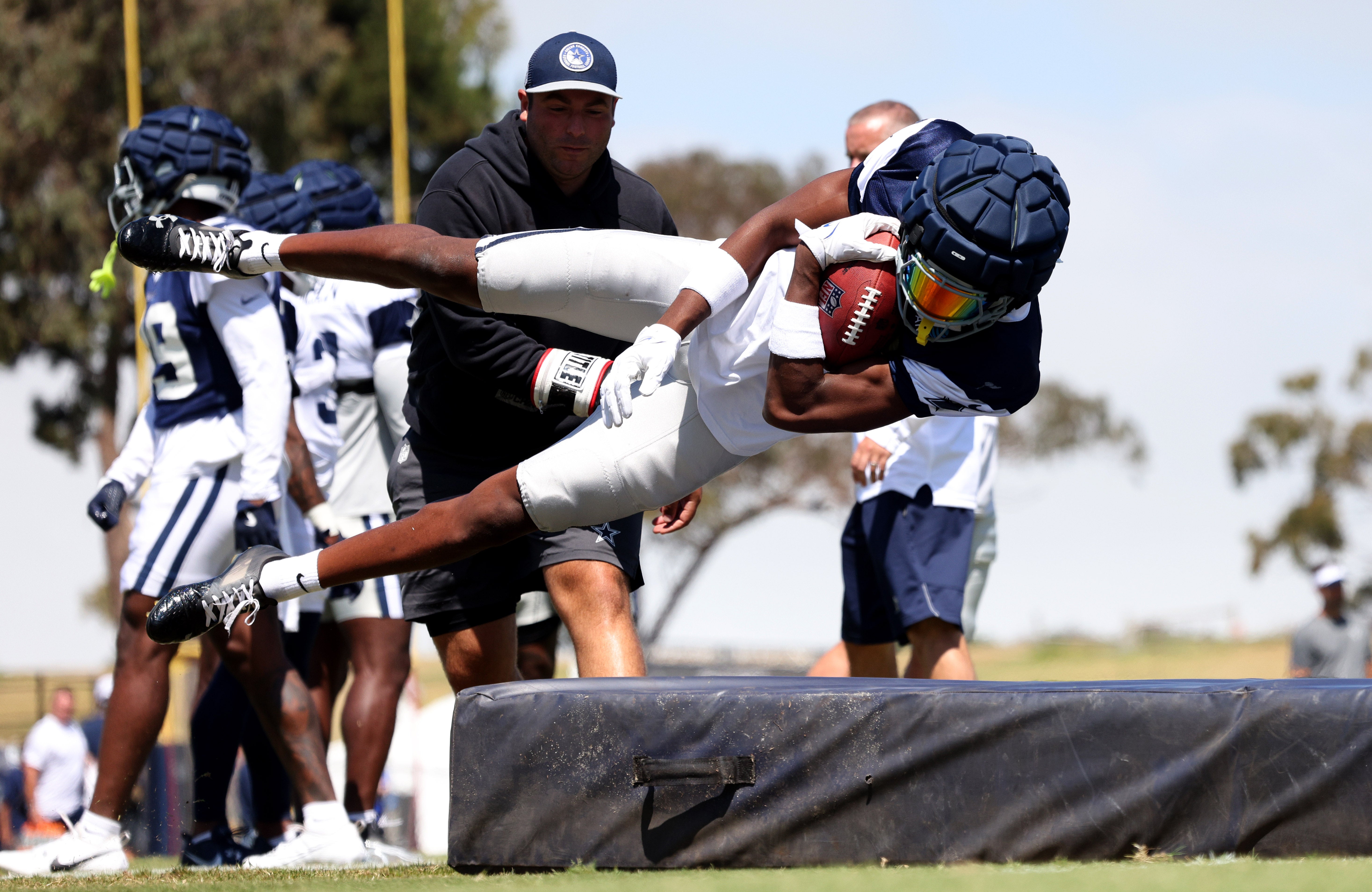 Dallas Cowboys safety Israel Mukuamu (24) jumps on a pad during training camp at the River Ridge Playing Fields in Oxnard, California.