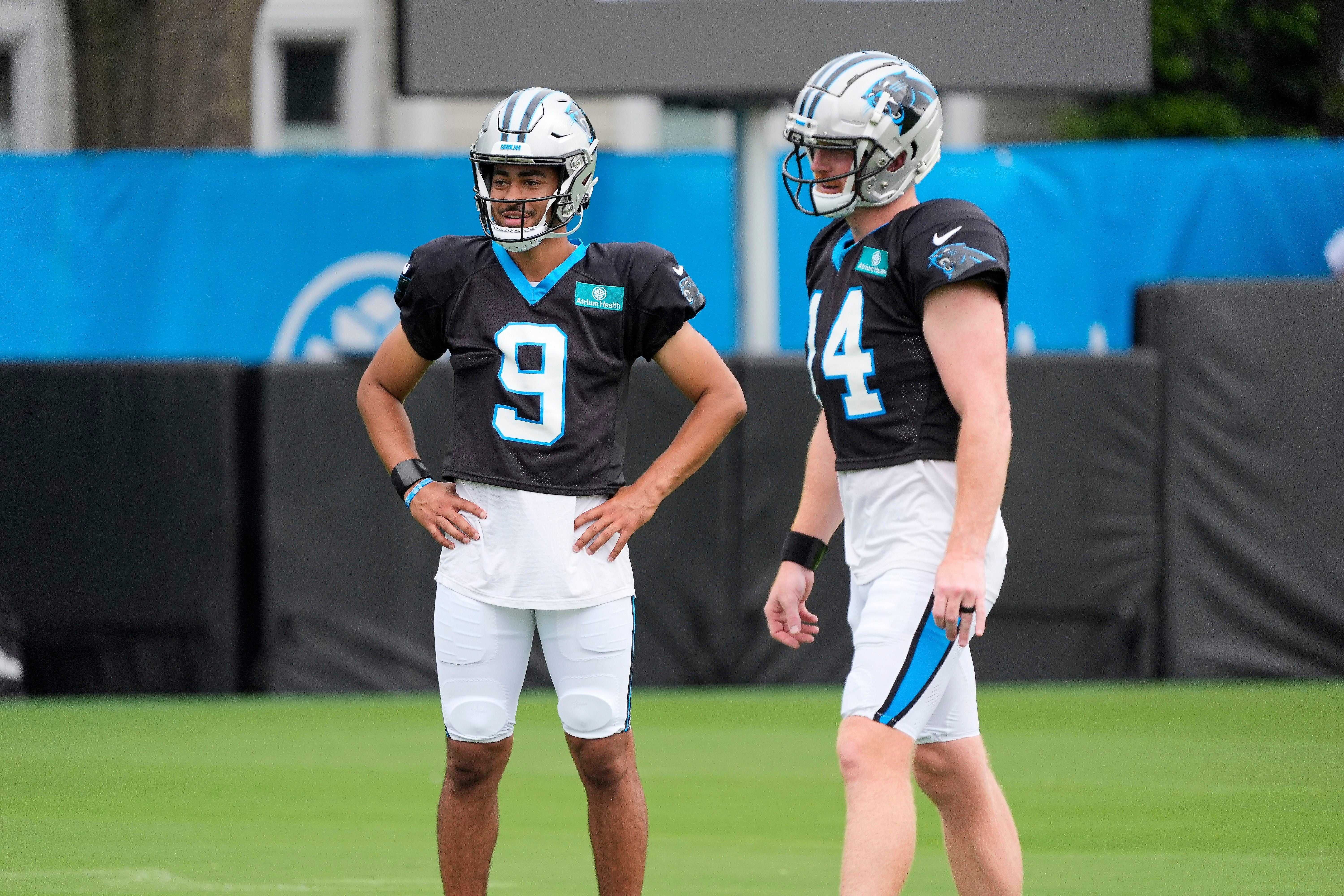 Jul 30, 2024; Charlotte, NC, USA; Carolina Panthers quarterback Bryce Young (9) and quarterback Andy Dalton (14) talk during training camp at Carolina Panthers Practice Fields. Mandatory Credit: Jim Dedmon-USA TODAY Sports