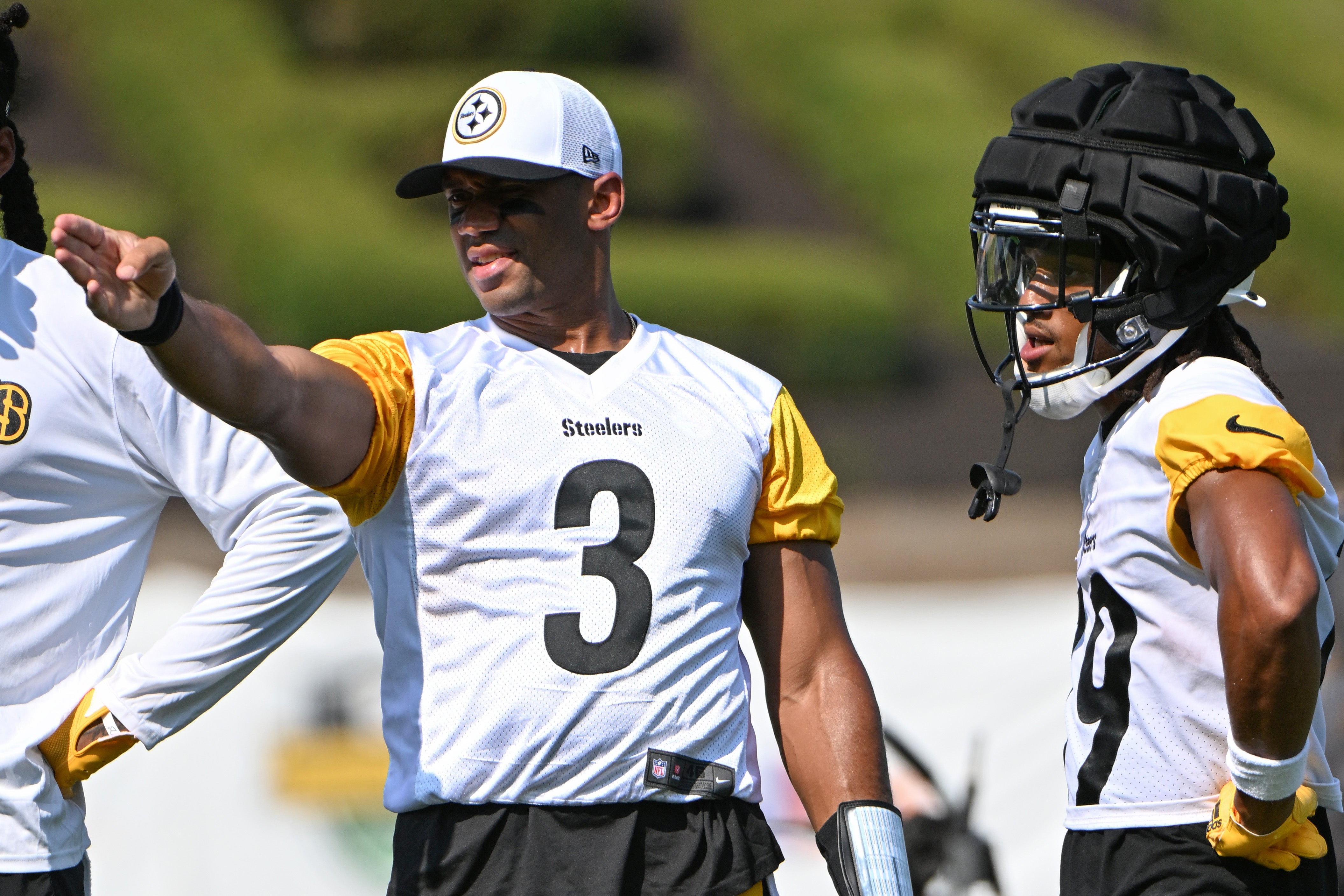 Jul 28, 2024; Latrobe, PA, USA; Pittsburgh Steelers quarterback Russell Wilson (3) talks to wide receiver Calvin Austin III (19) during training camp at Saint Vincent College. Mandatory Credit: Barry Reeger-USA TODAY Sports  
