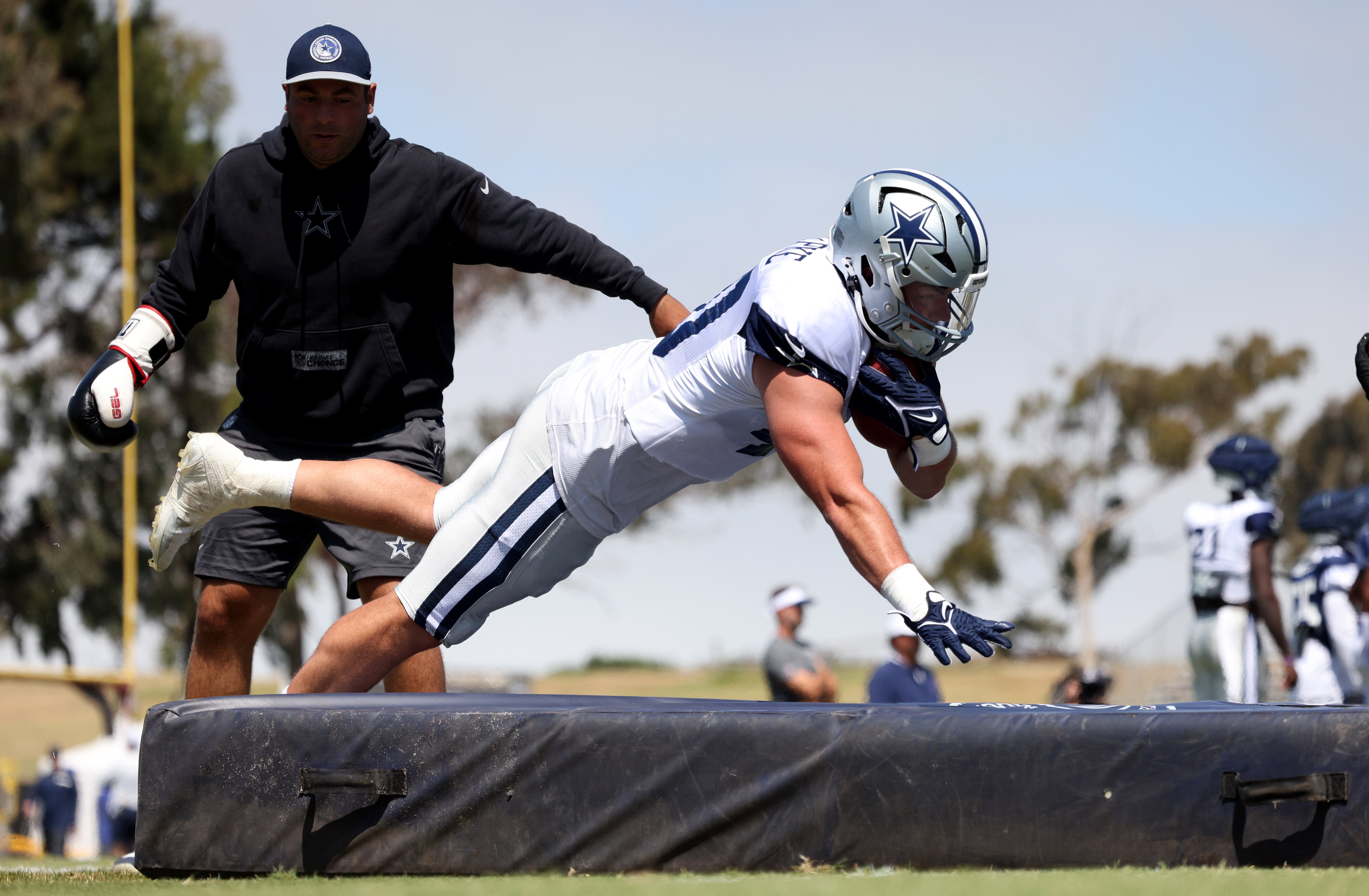 Dallas Cowboys running back Hunter Luepke (40) jumps on a pad during training camp at the River Ridge Playing Fields in Oxnard, California.