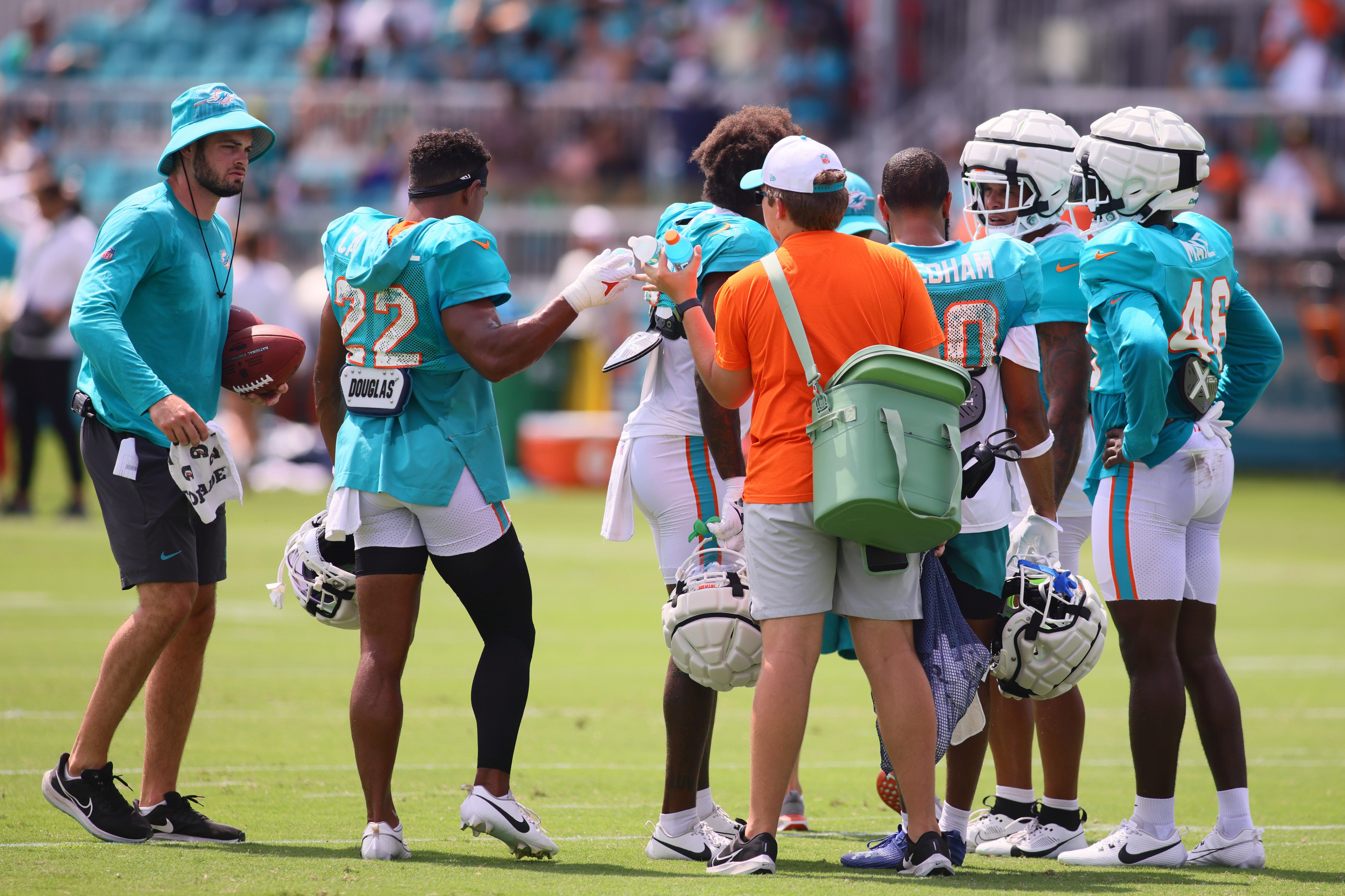 Jul 29, 2024; Miami Gardens, FL, USA; Miami Dolphins safety Elijah Campbell (22) receives a bottle of water during training camp at Baptist Health Training Complex.