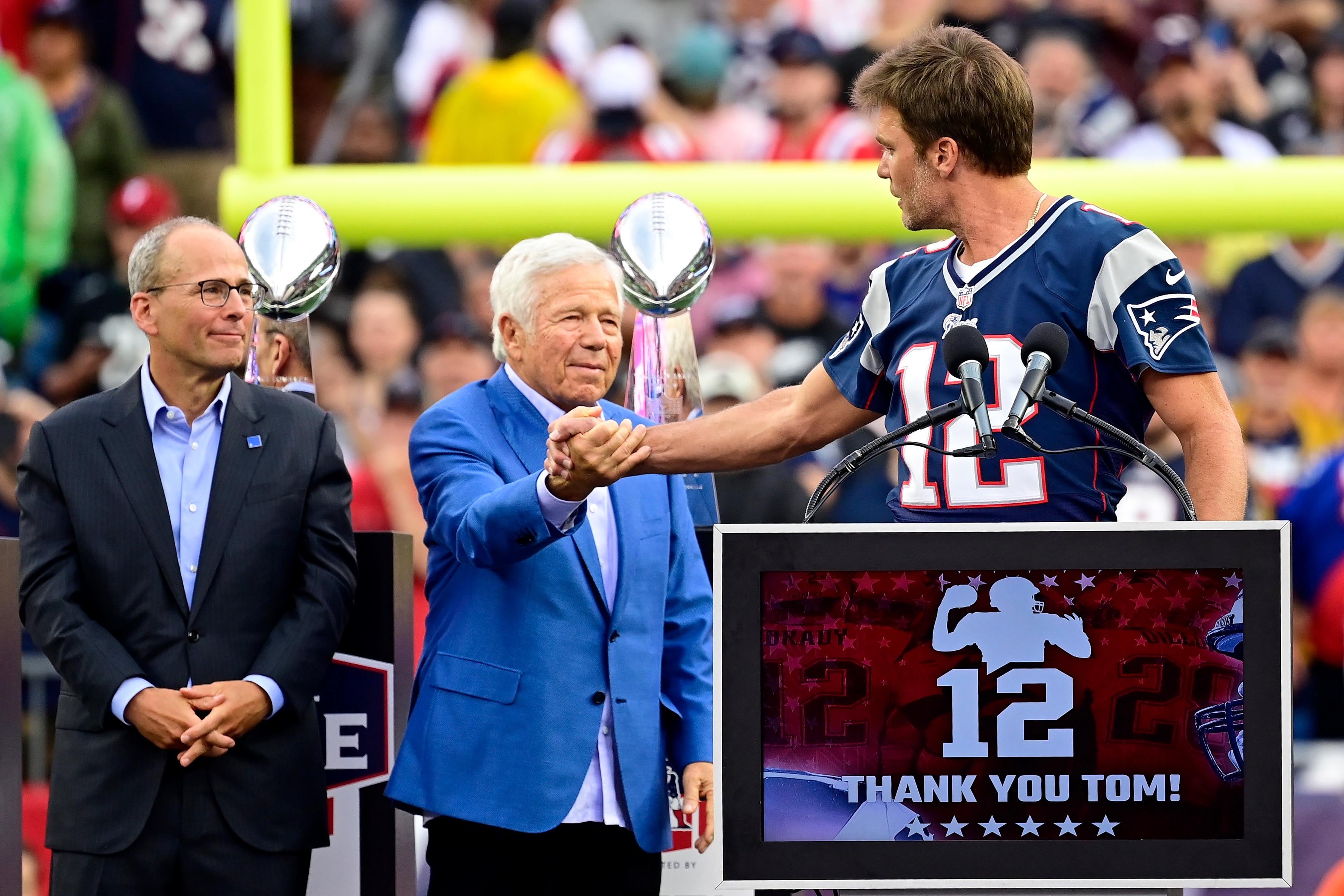 Sep 10, 2023; Foxborough, Massachusetts, USA; New England Patriots former quarterback Tom Brady shakes hands with New England Patriots owner Robert Kraft during a halftime ceremony in his honor during the game between the Philadelphia Eagles and New England Patriots at Gillette Stadium.
