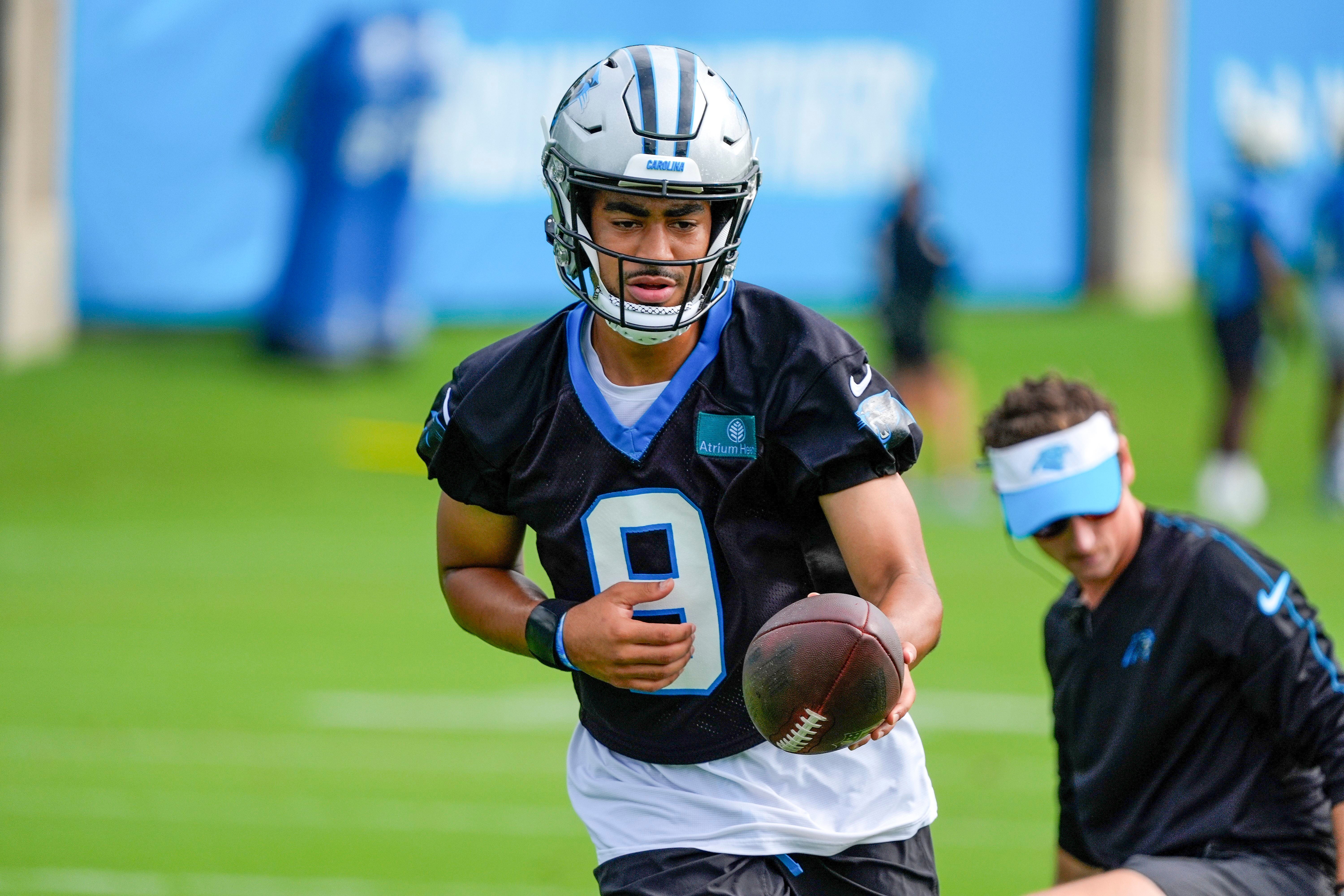 Jul 24, 2024; Charlotte, NC, USA; Carolina Panthers quarterback Bryce Young (9) hands the ball off at Carolina Panthers Practice Fields. Mandatory Credit: Jim Dedmon-USA TODAY Sports