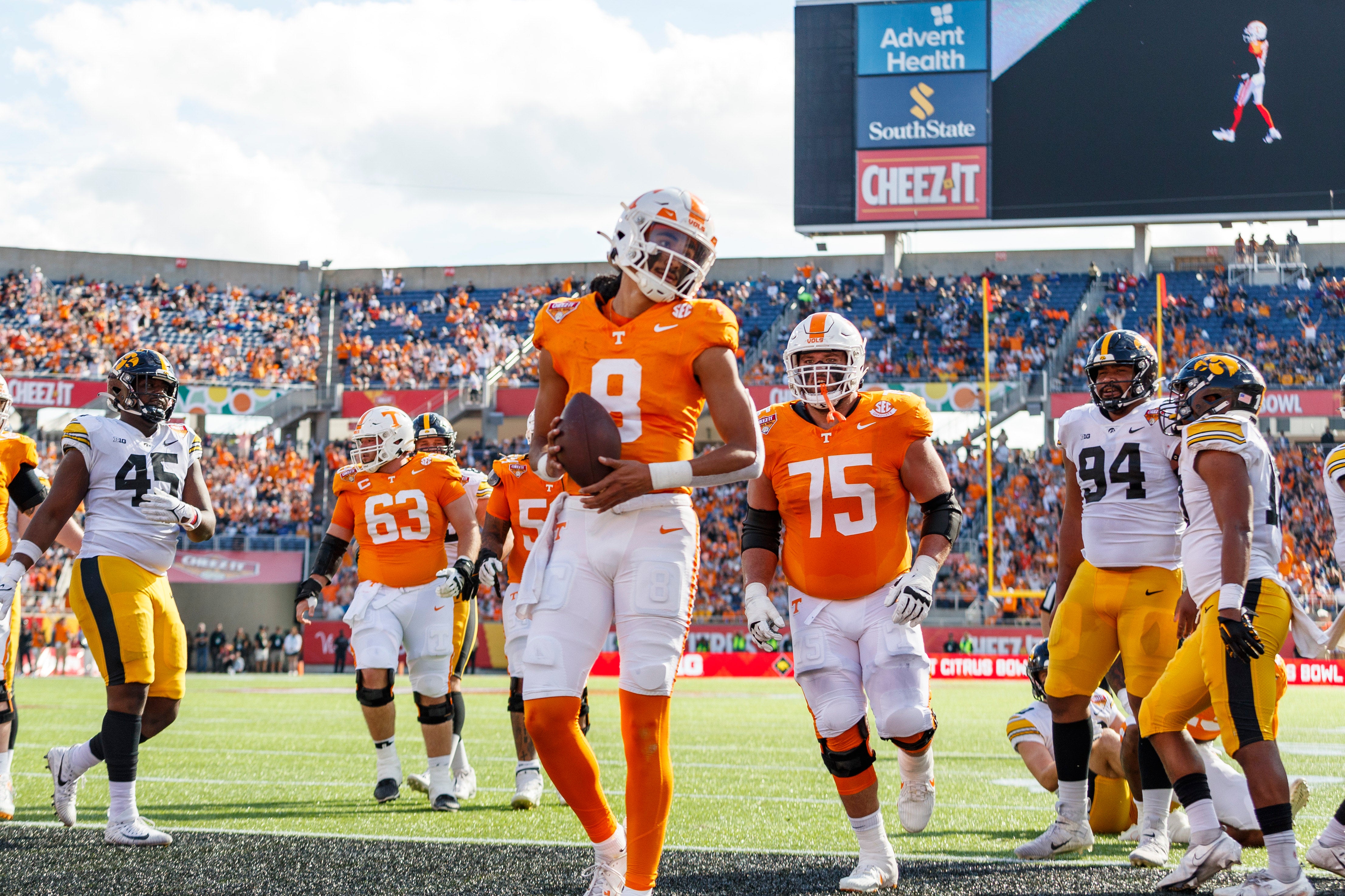Jan 1, 2024; Orlando, FL, USA; Tennessee Volunteers quarterback Nico Iamaleava (8) scores a touchdown against the Iowa Hawkeyes during the second quarter at Camping World Stadium. 