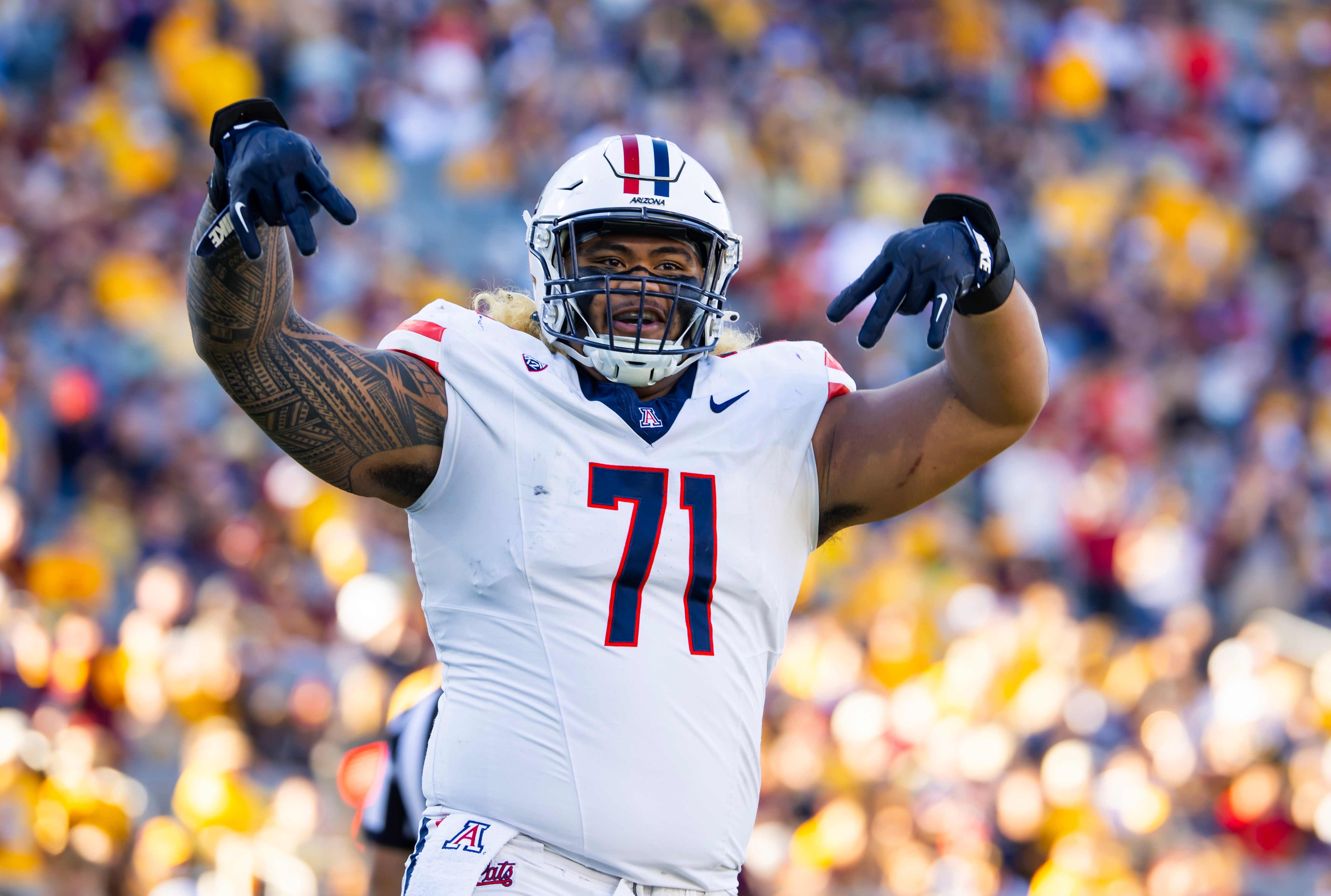 Nov 25, 2023; Tempe, Arizona, USA; Arizona Wildcats offensive lineman Jonah Savaiinaea (71) celebrates a touchdown against the Arizona State Sun Devils in the second half of the Territorial Cup at Mountain America Stadium.
