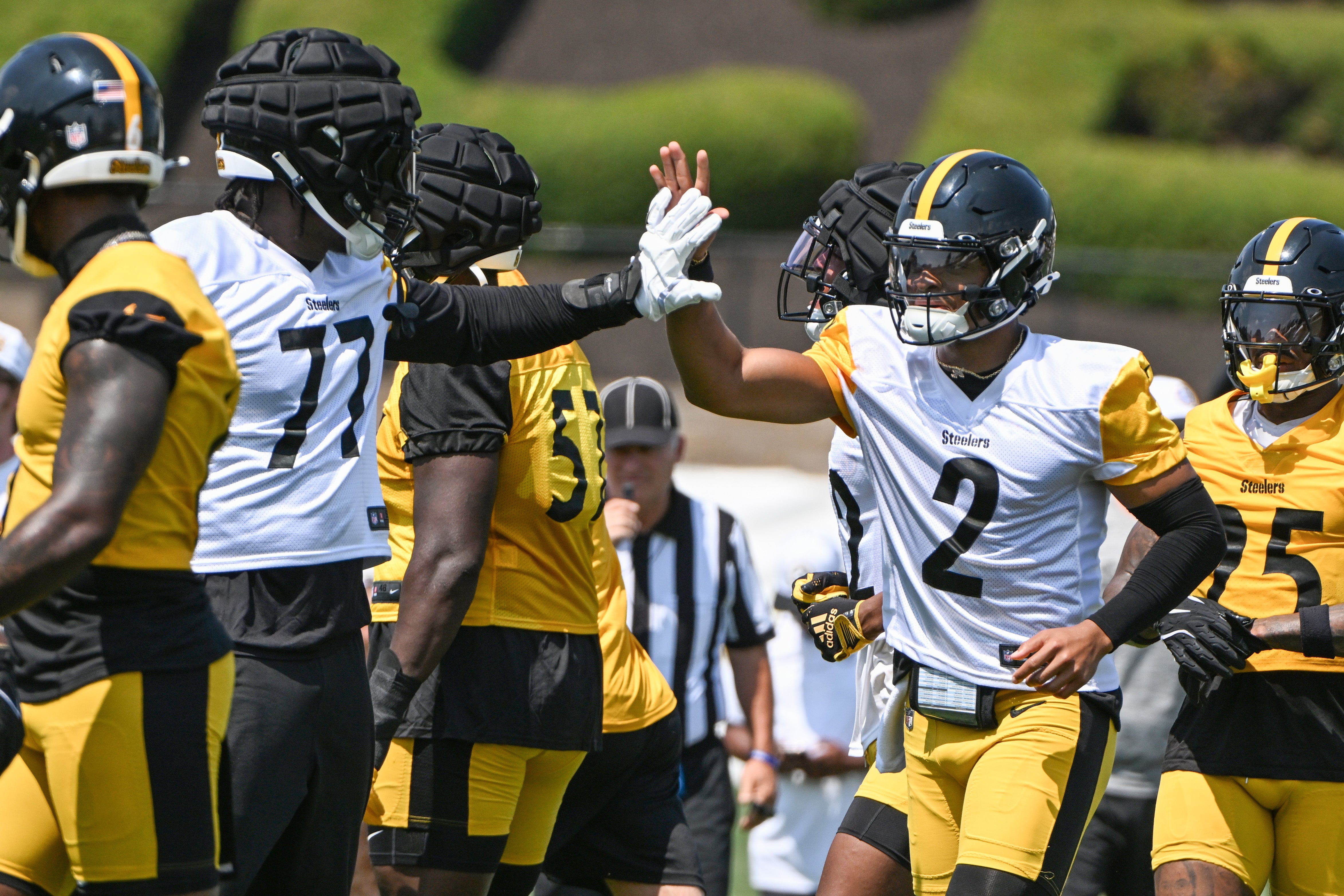 Jul 27, 2024; Latrobe, PA, USA; Pittsburgh Steelers quarterback Justin Fields celebrates with offensive tackle Broderick Jones (77) after scoring during training camp at Saint Vincent College. Mandatory Credit: Barry Reeger-USA TODAY Sports  
