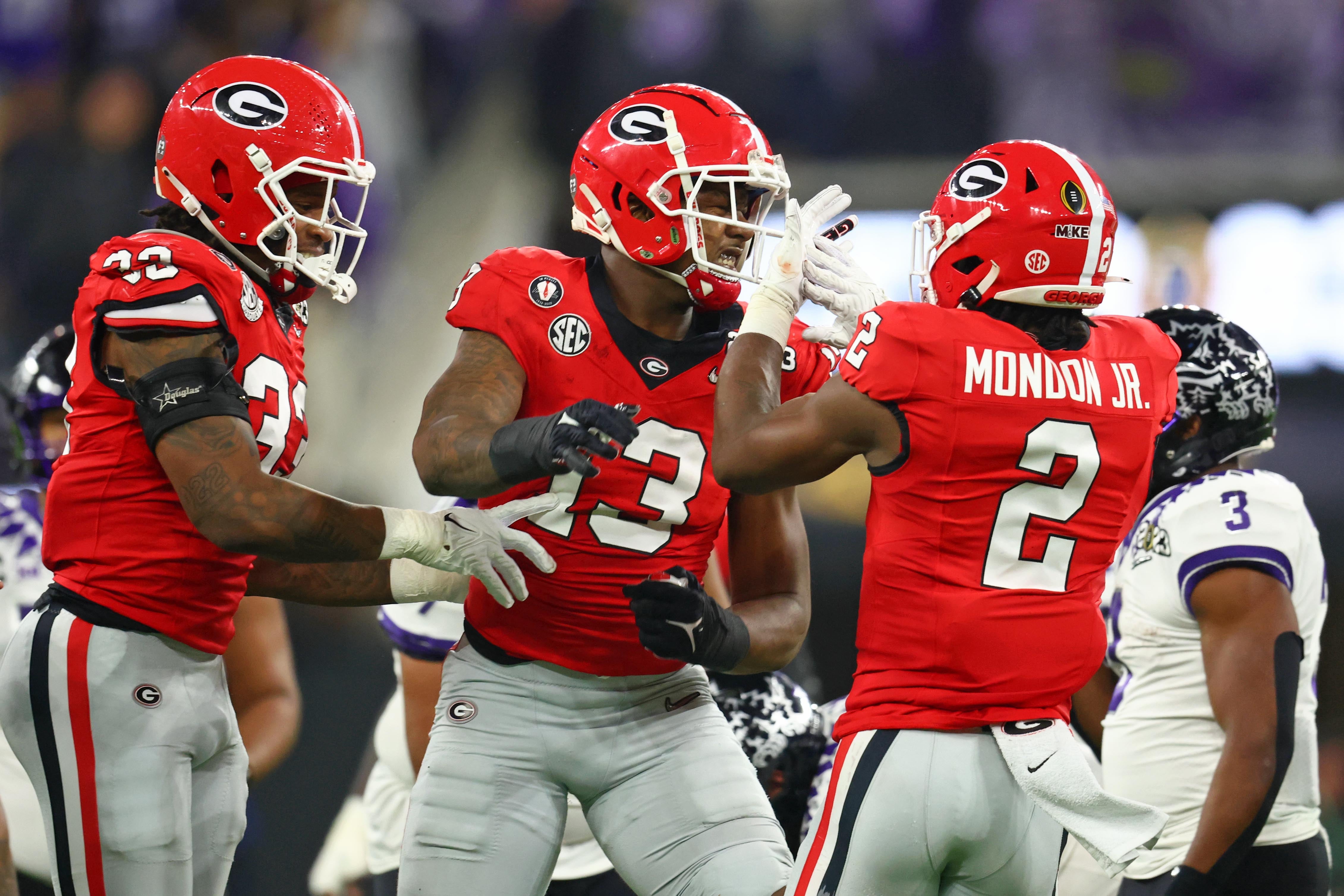 Georgia Bulldogs linebacker Chaz Chambliss (32) and defensive lineman Mykel Williams (13) and linebacker Smael Mondon Jr. (2) reacts after a play against the TCU Horned Frogs during the first quarter.