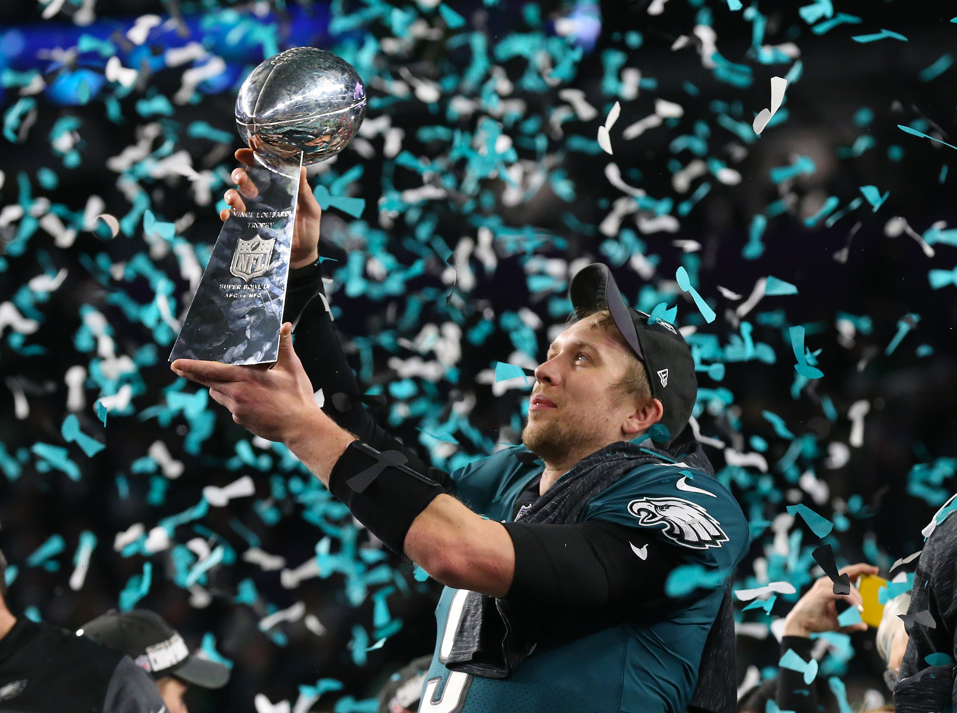 Philadelphia Eagles quarterback Nick Foles (9) hoist the Vince Lombardi Trophy after a victory against the New England Patriots in Super Bowl LII at U.S. Bank Stadium.