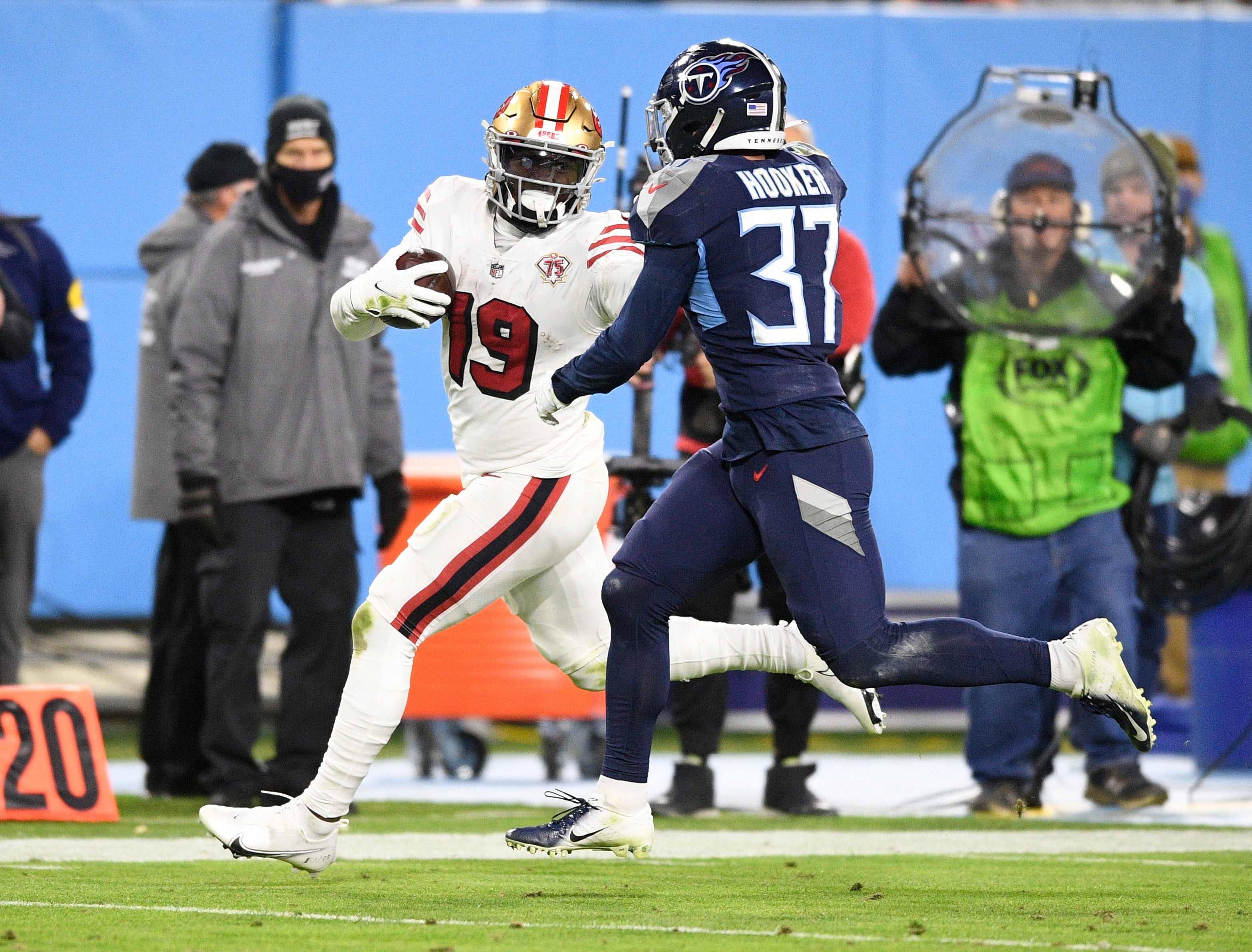 Dec 23, 2021; Nashville, Tennessee, USA; San Francisco 49ers wide receiver Deebo Samuel (19) and Tennessee Titans safety Amani Hooker (37) during the second half at Nissan Stadium.