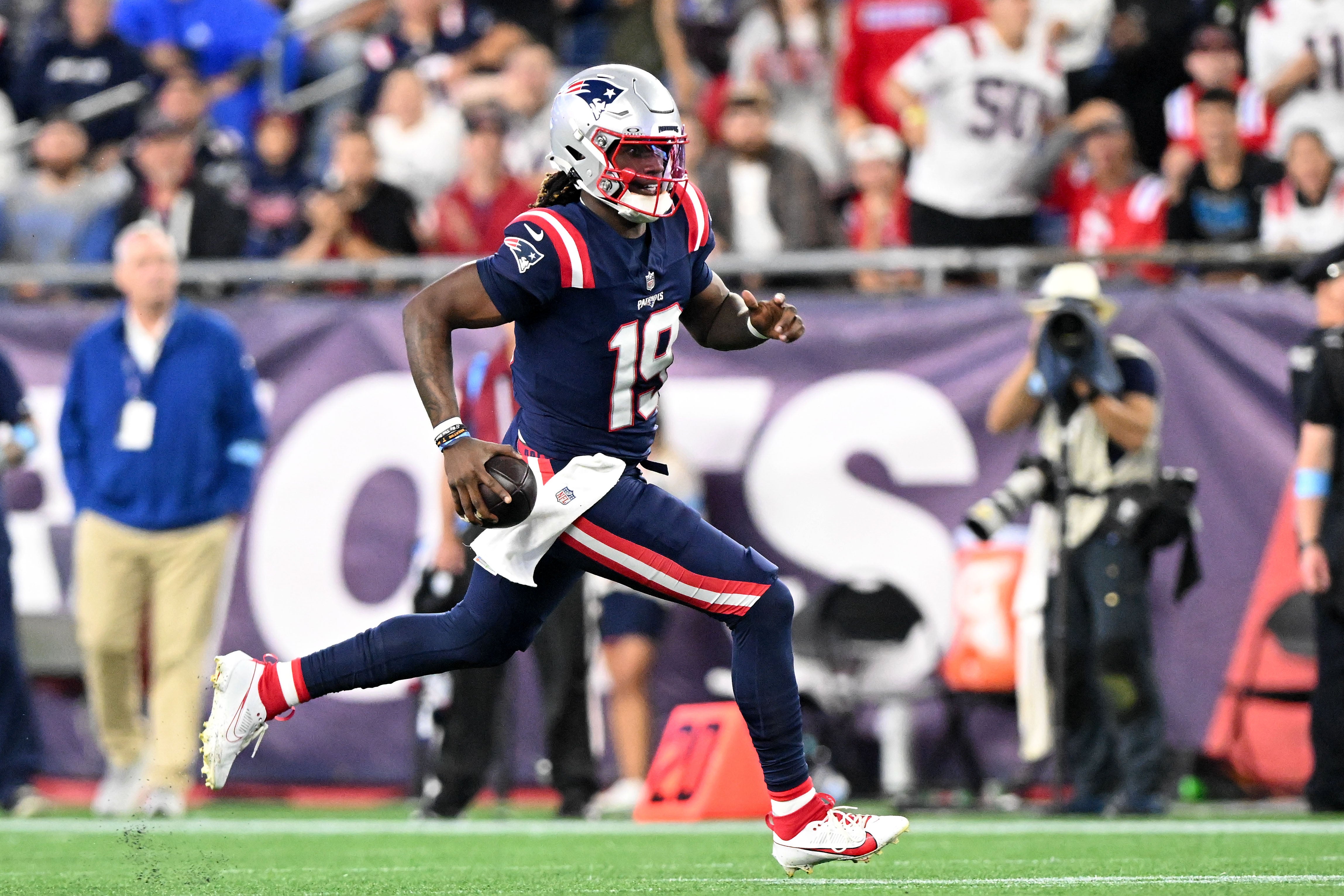 Aug 8, 2024; Foxborough, Massachusetts, USA; New England Patriots quarterback Joe Milton III (19) runs against against the Carolina Panthers during the second half at Gillette Stadium.