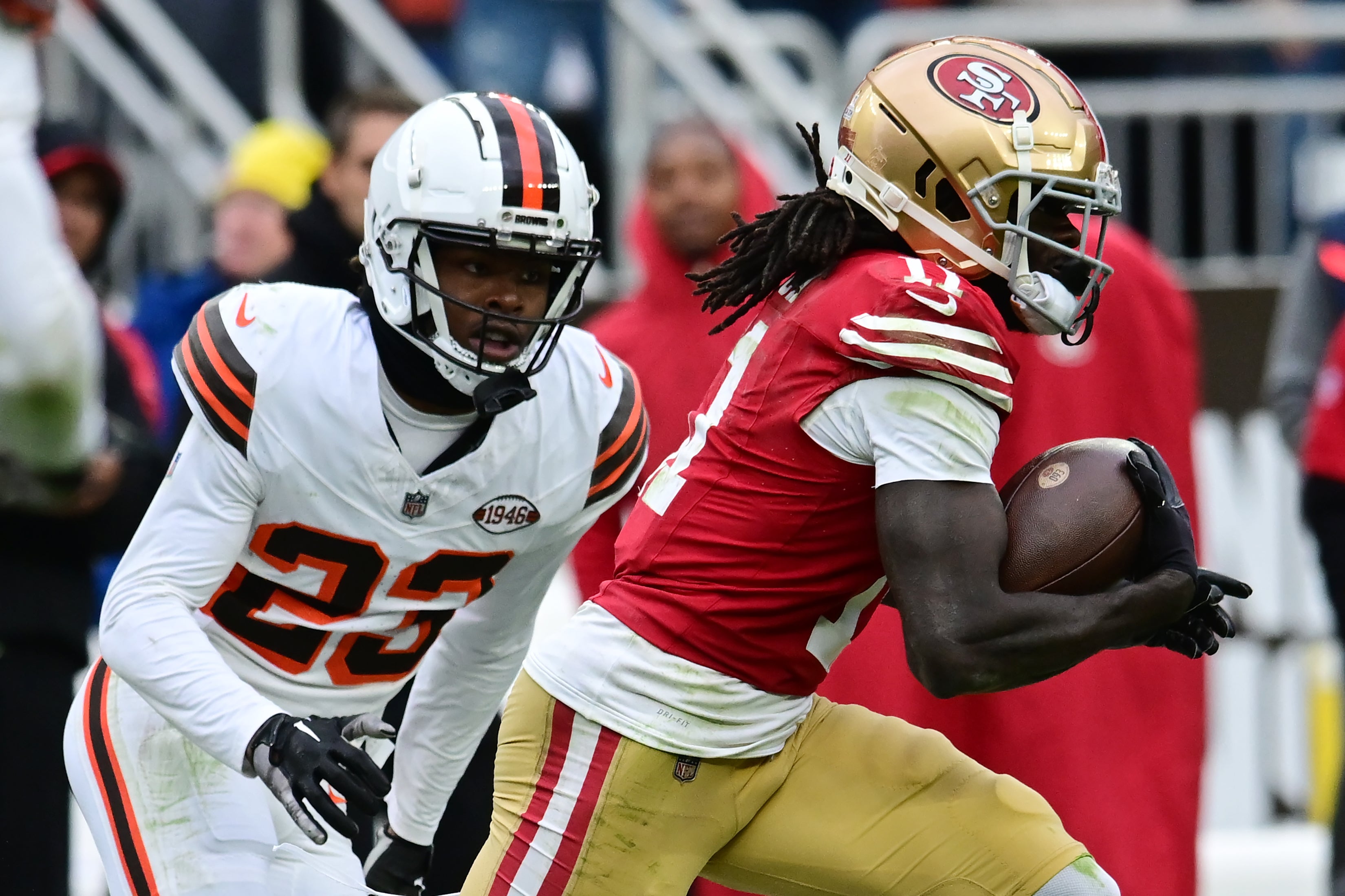 Oct 15, 2023; Cleveland, Ohio, USA; San Francisco 49ers wide receiver Brandon Aiyuk (11) runs with the ball after a catch as Cleveland Browns cornerback Martin Emerson Jr. (23) defends during the second half at Cleveland Browns Stadium.