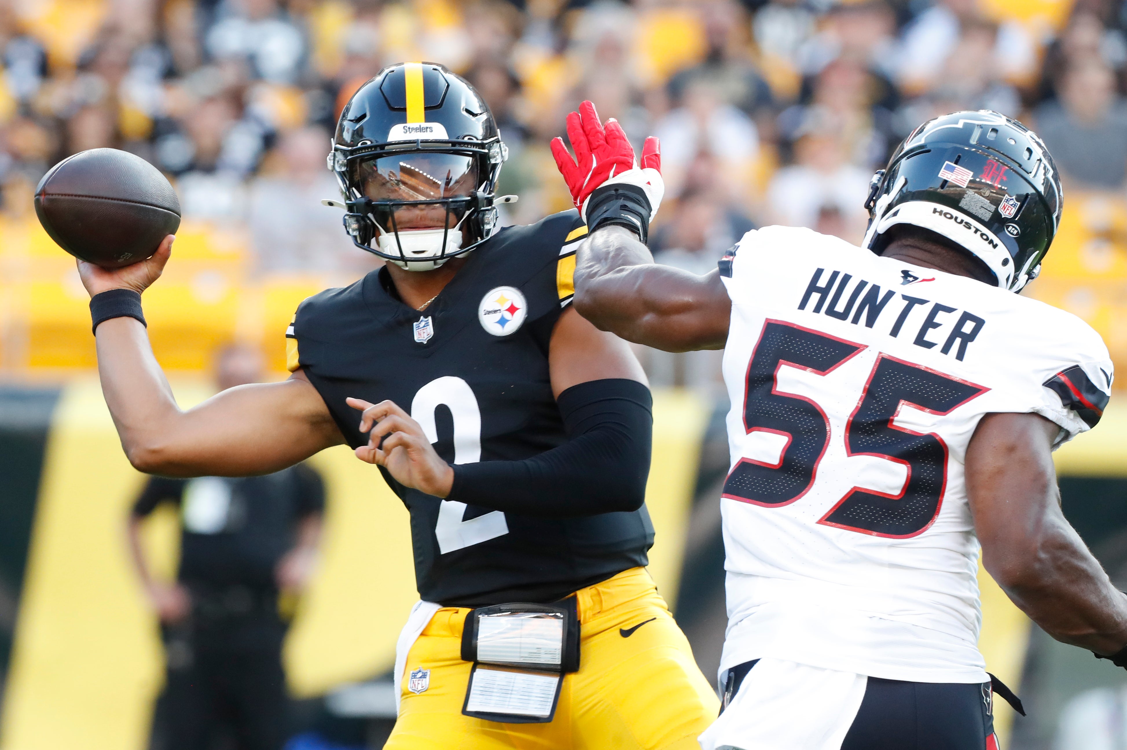 Aug 9, 2024; Pittsburgh, Pennsylvania, USA; Pittsburgh Steelers quarterback Justin Fields (2) passes against pressure from Houston Texans defensive end Danielle Hunter (55) during the first quarter at Acrisure Stadium. Mandatory Credit: Charles LeClaire-USA TODAY Sports