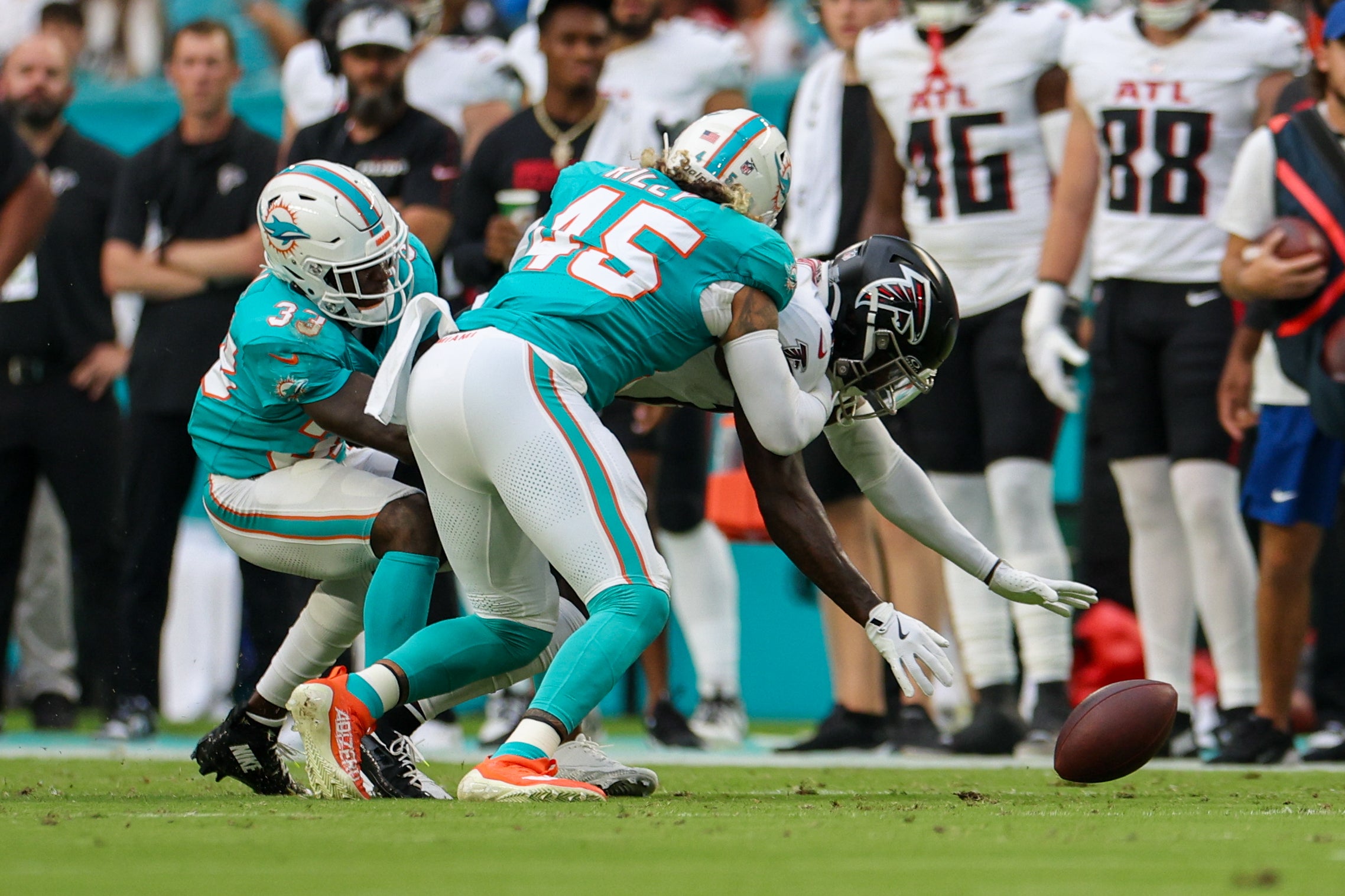 Aug 9, 2024; Miami Gardens, Florida, USA; Atlanta Falcons wide receiver Chris Blair (19) fumbles the ball while pressured by Miami Dolphins linebacker Duke Riley (45) in the first quarter during preseason at Hard Rock Stadium.